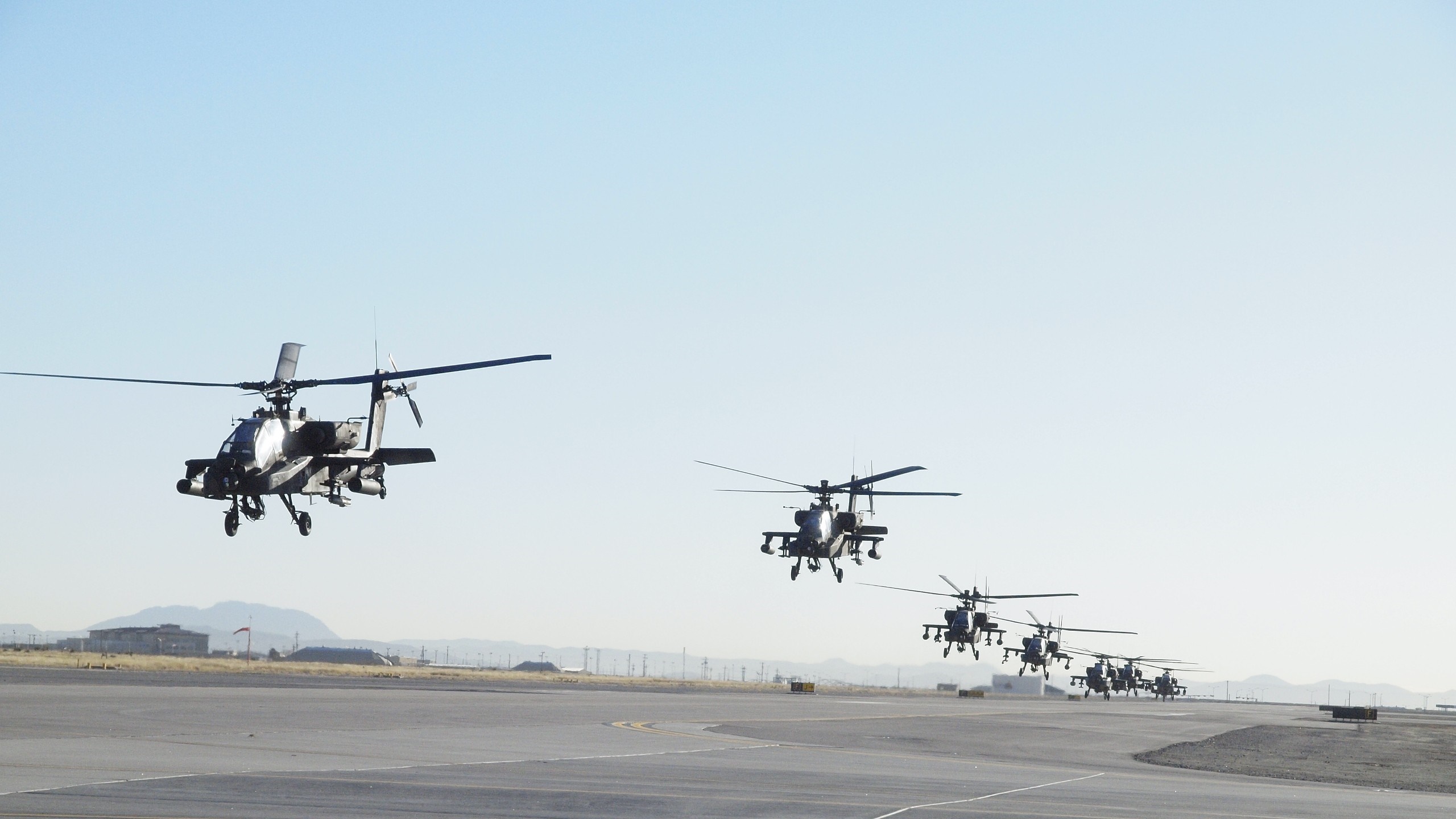 Boeing AH-64 Apache helicopters in formation flight HD Wallpaper