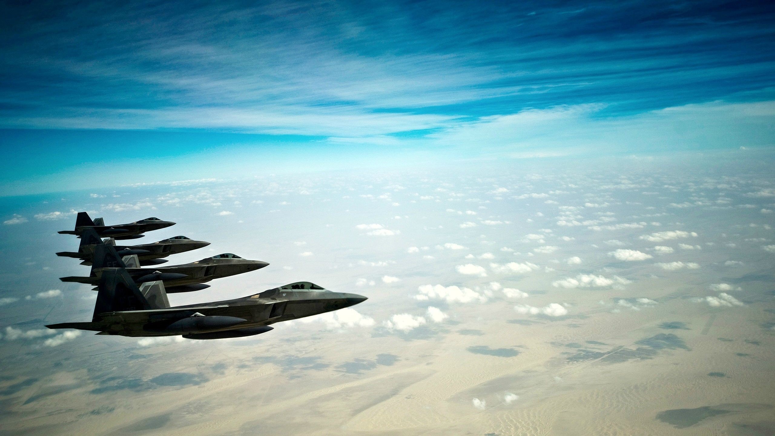 Four F-22 Raptor fighter jets flying in formation HD Wallpaper