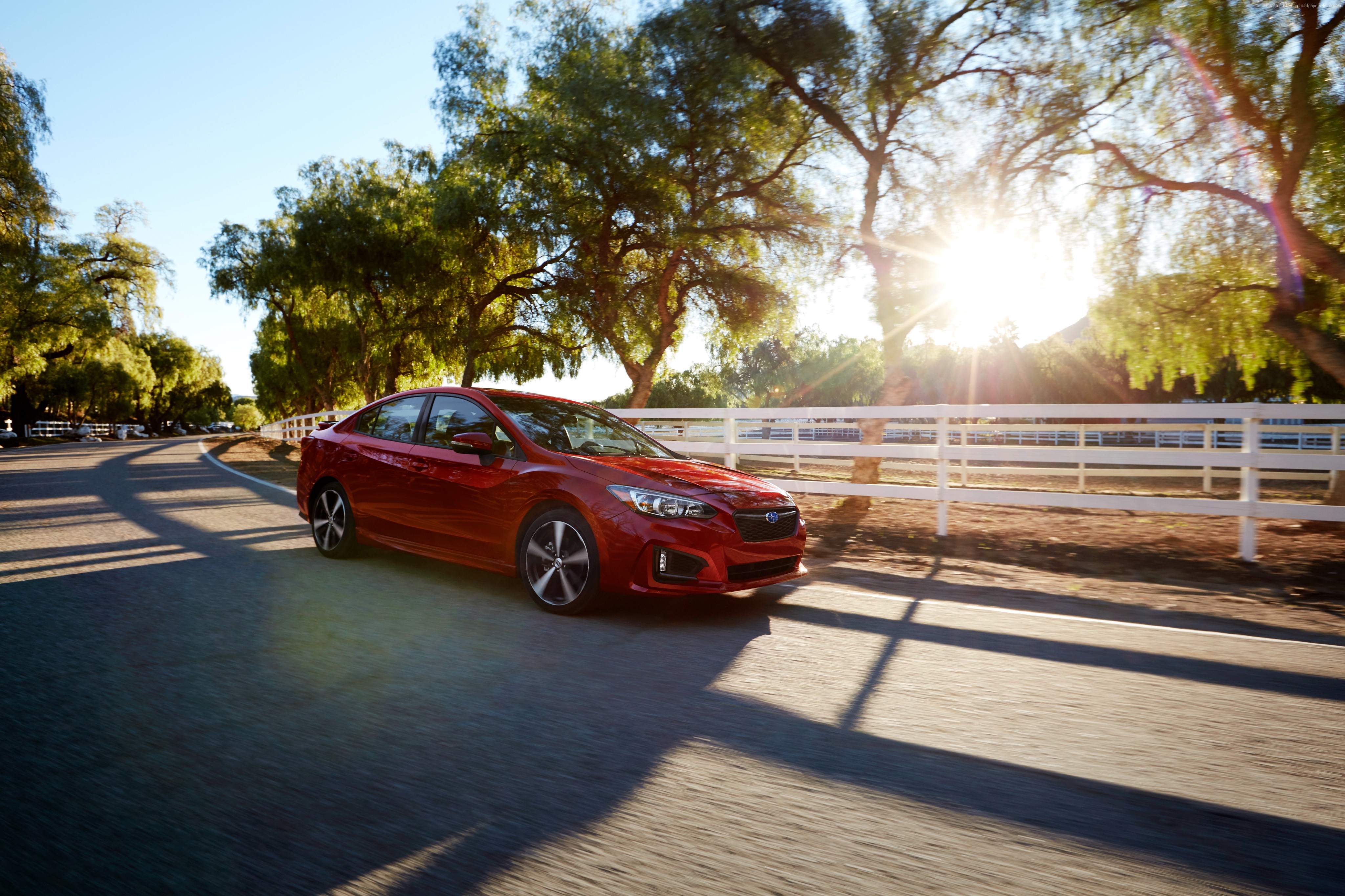 Red Subaru Impreza Sedan driving on a road HD Wallpaper