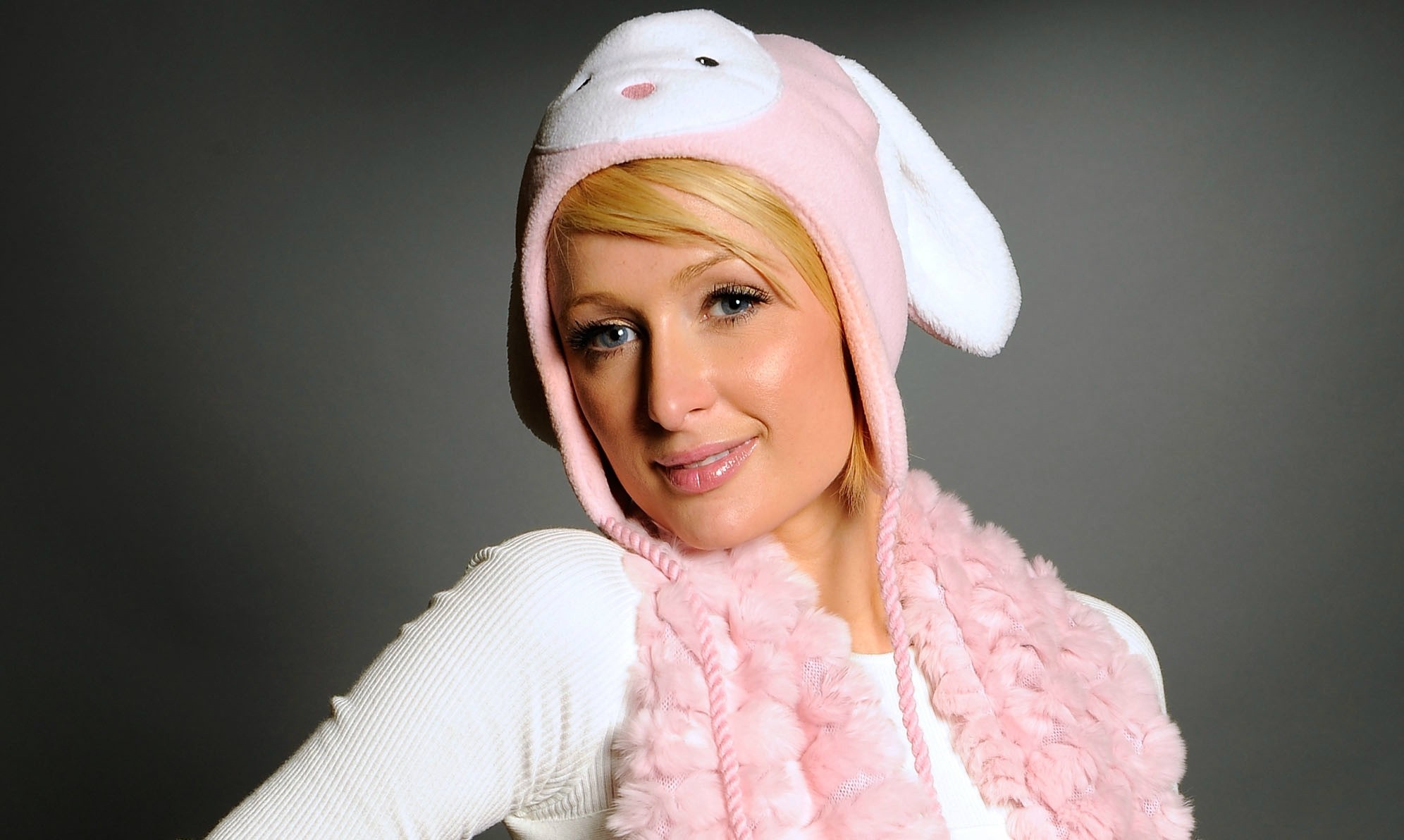 Paris Hilton wearing a pink bunny hat and scarf HD Wallpaper