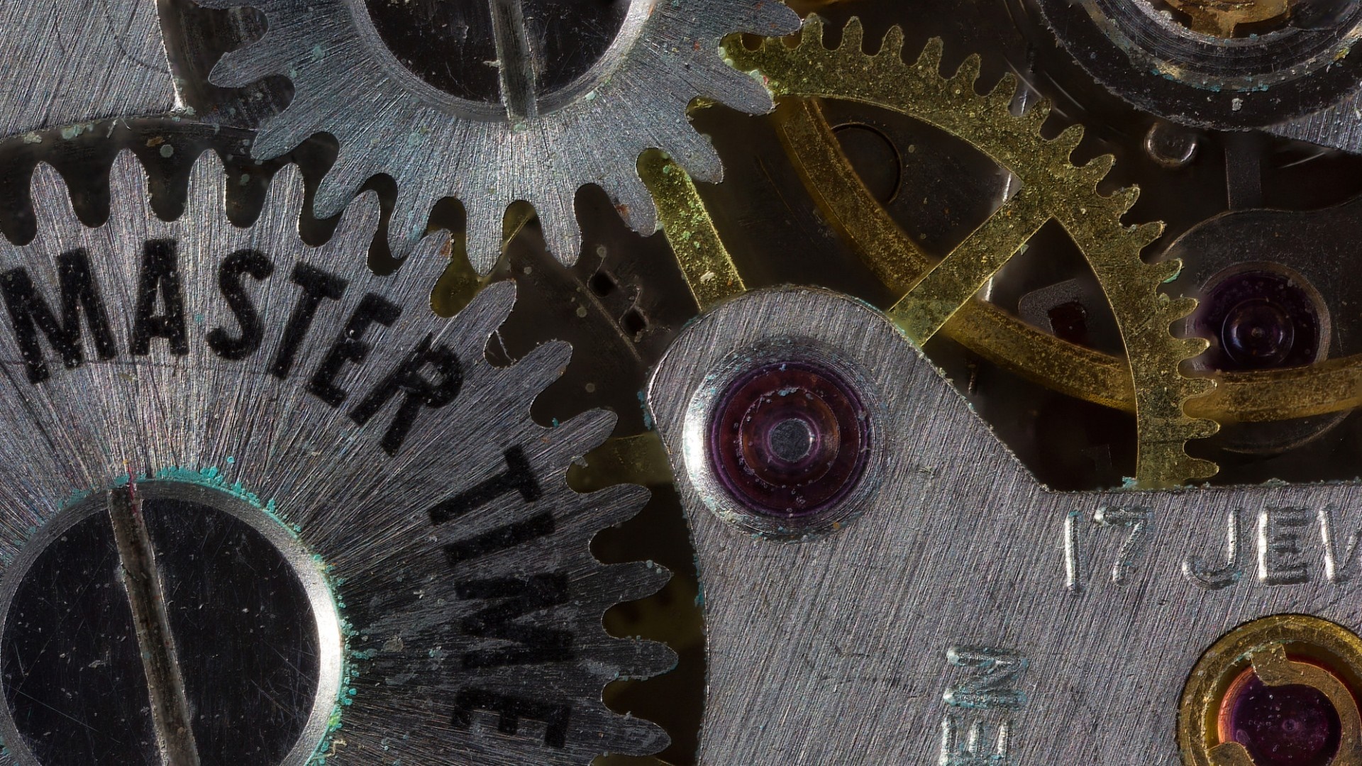 Close-up of watch gears with text 'MASTER TIME' and '17 JEWELS' HD Wallpaper