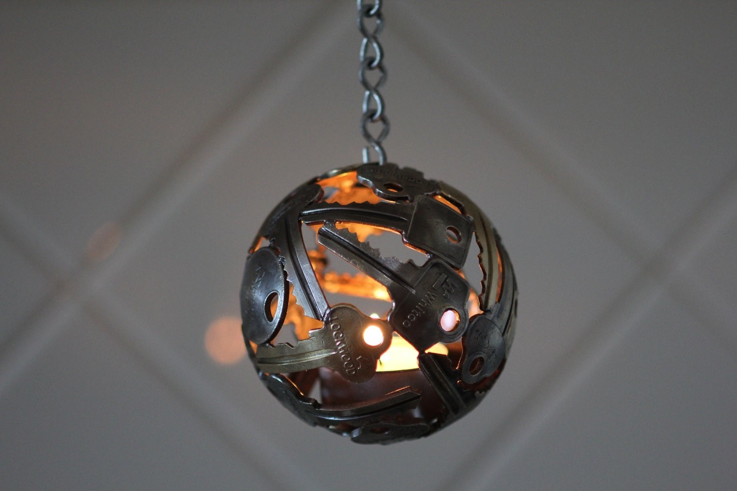 Hanging sphere lantern made of keys with candle HD Wallpaper
