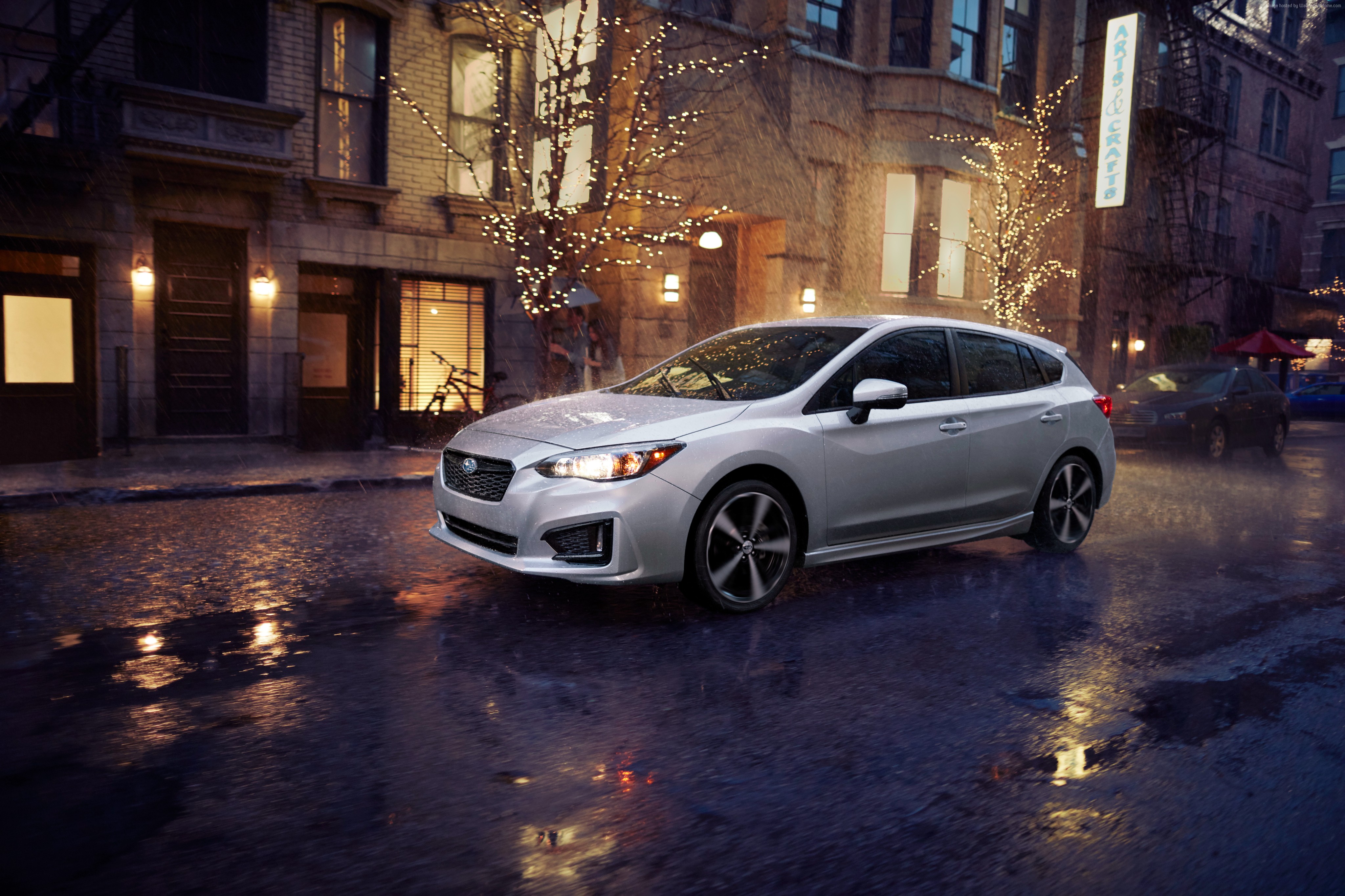 Silver Subaru Impreza 5-door sport on wet city street HD Wallpaper