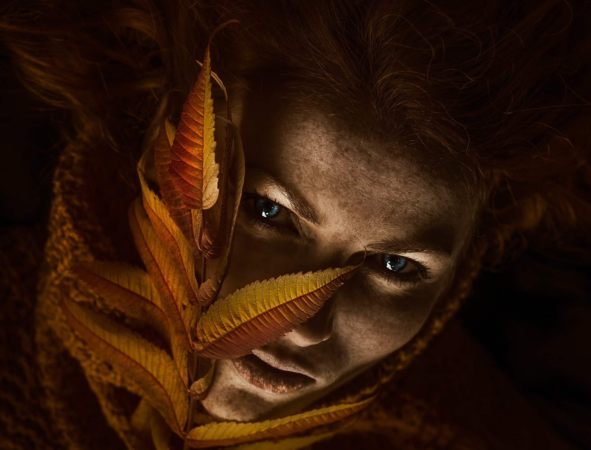 Woman with autumn leaves covering her face HD Wallpaper