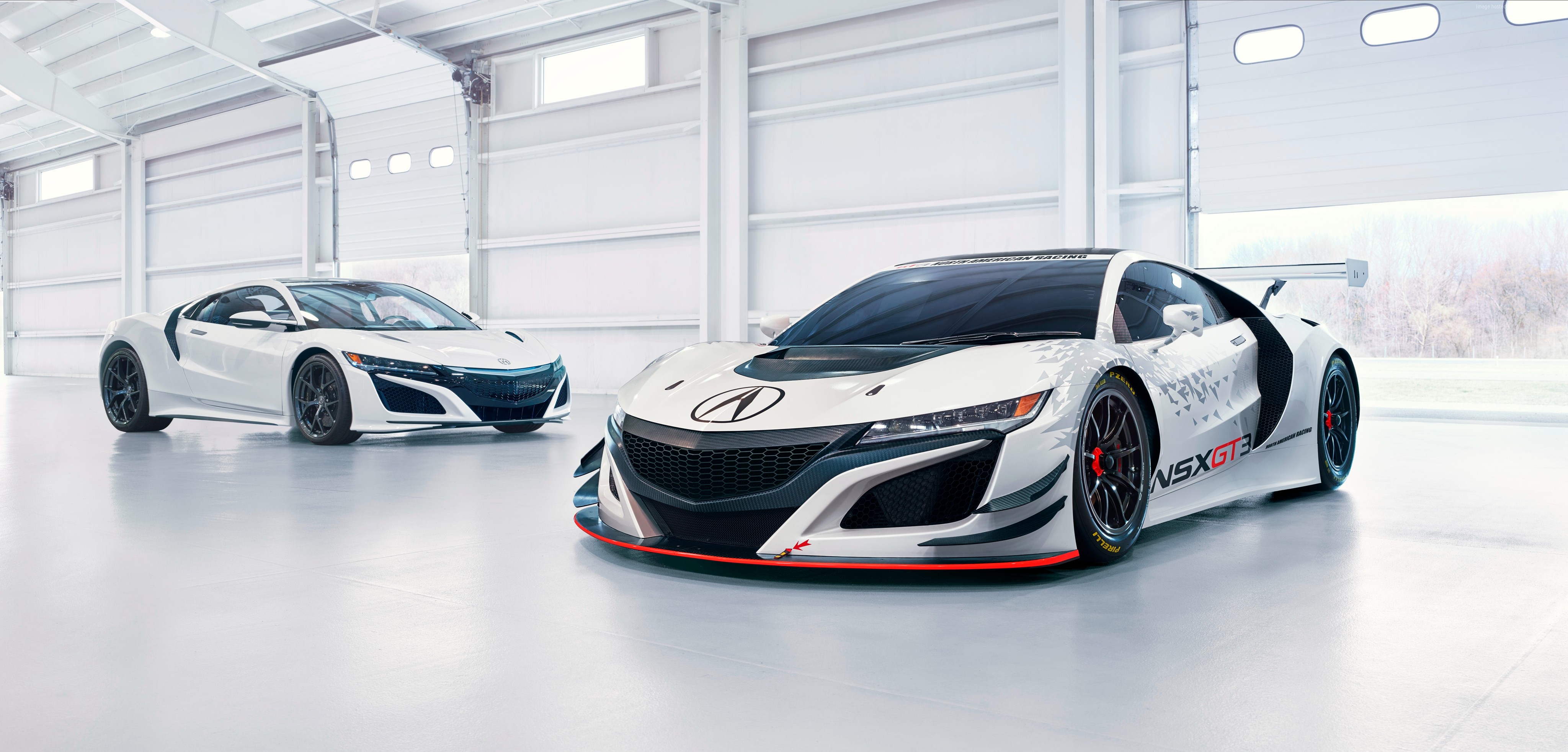 Two white Acura NSX GT3 cars in a garage HD Wallpaper
