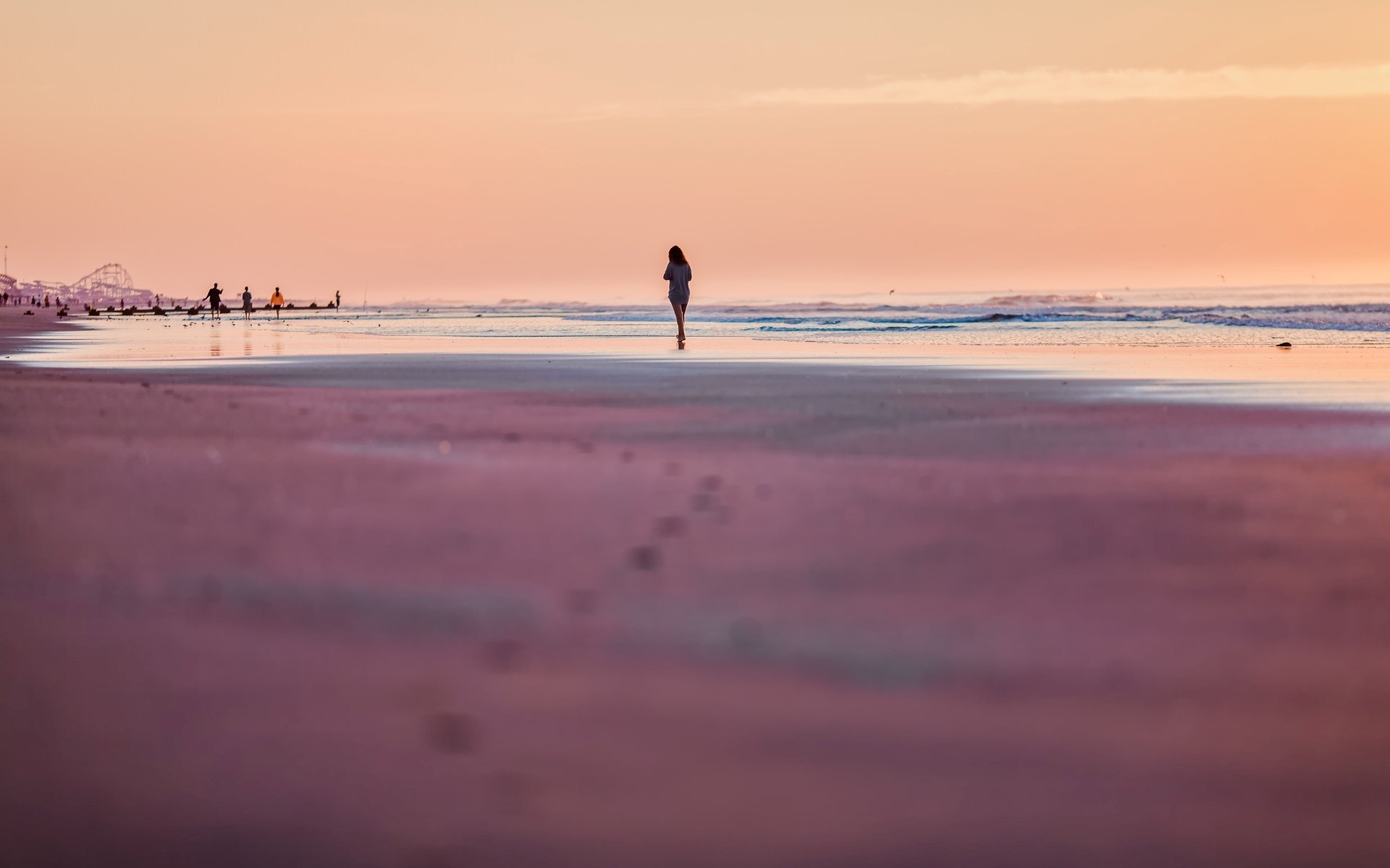 Woman walking on beach at sunset HD Wallpaper