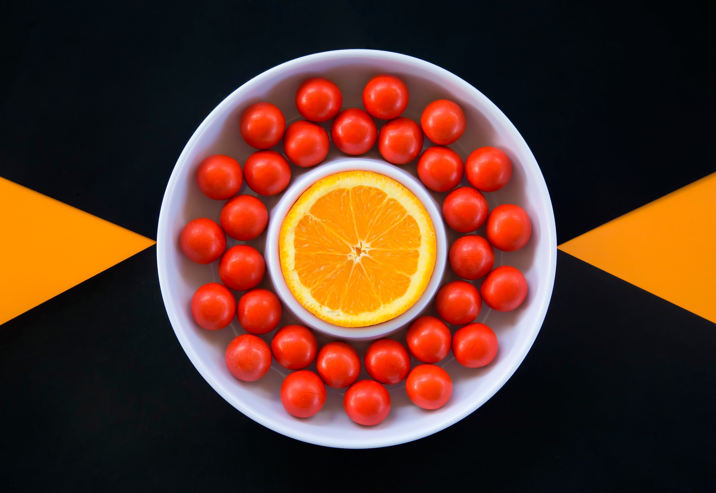 Orange slice and cherry tomatoes in a bowl HD Wallpaper