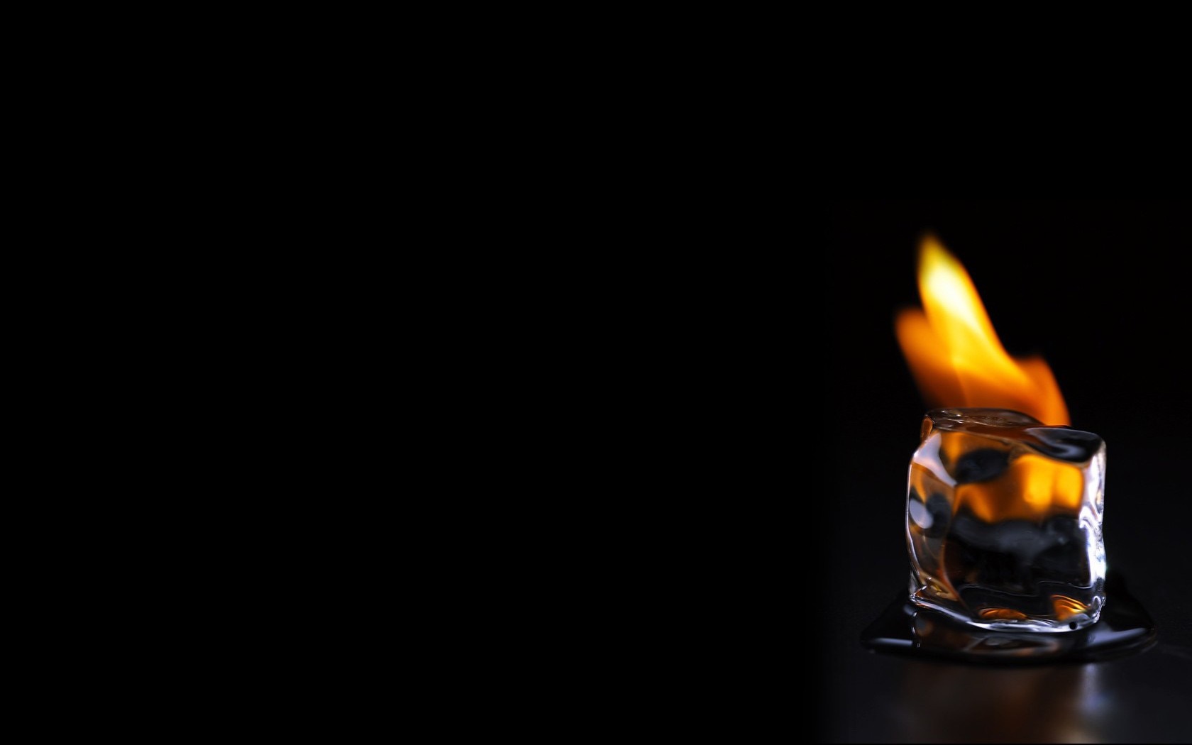 Ice cube on fire with melting water HD Wallpaper