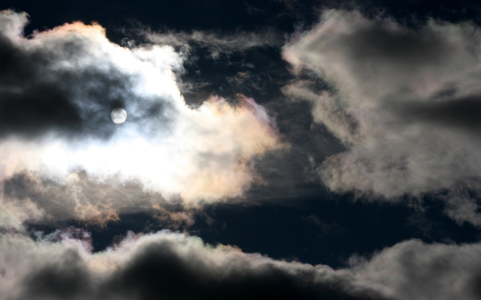 Sun peeking through dark clouds HD Wallpaper