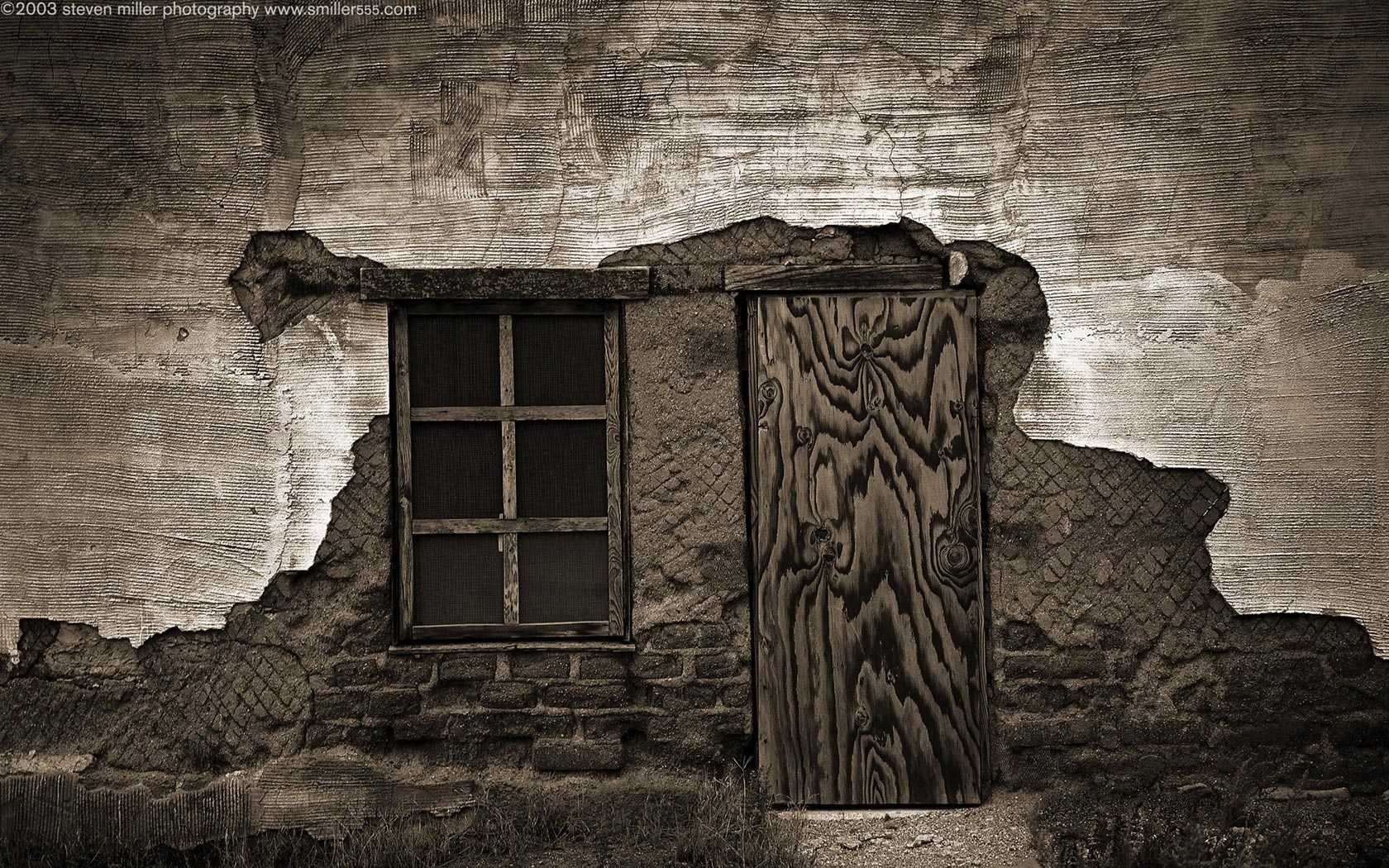 Dilapidated wall with a window and a wooden door HD Wallpaper