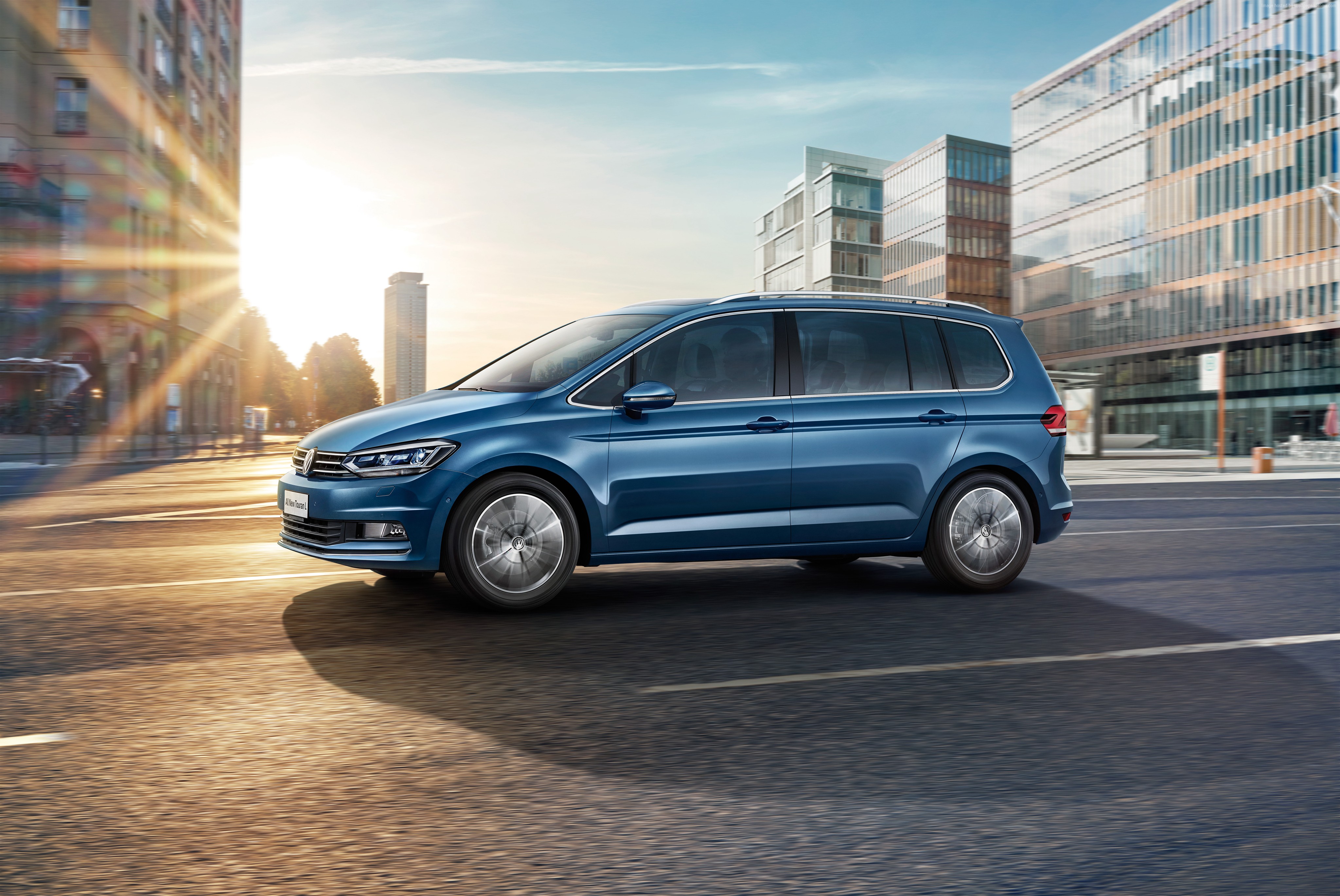 Blue Volkswagen Touran L driving in a city HD Wallpaper