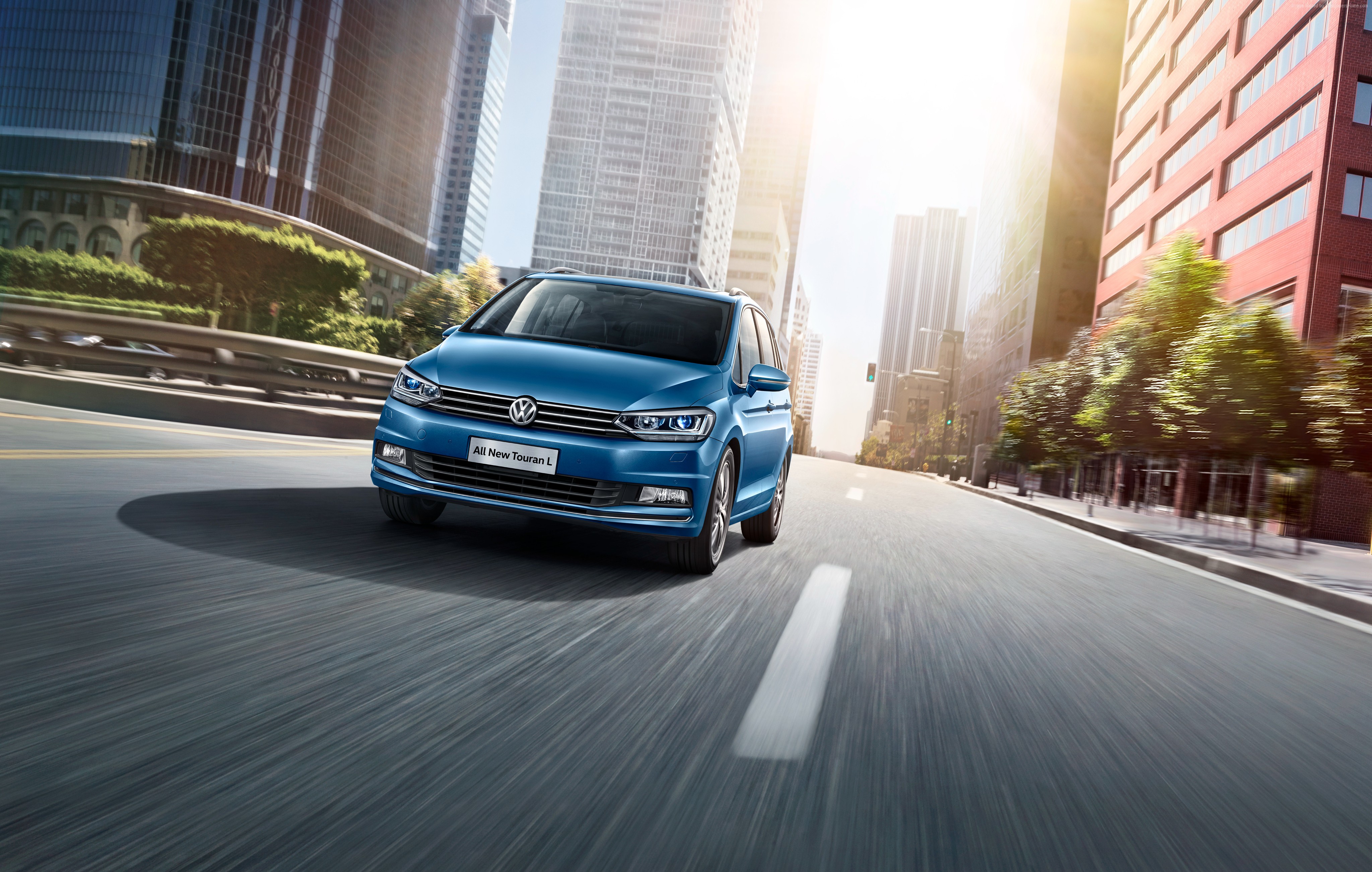 Blue Volkswagen Touran L driving in city HD Wallpaper