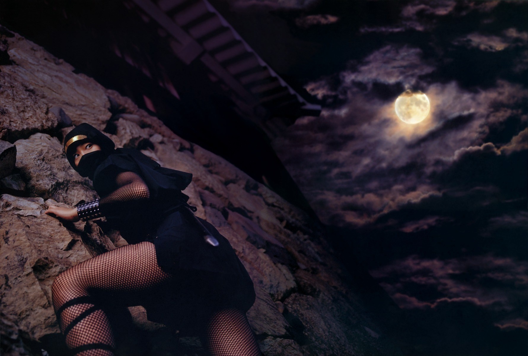 Ninja climbing a rocky cliff under the moon HD Wallpaper