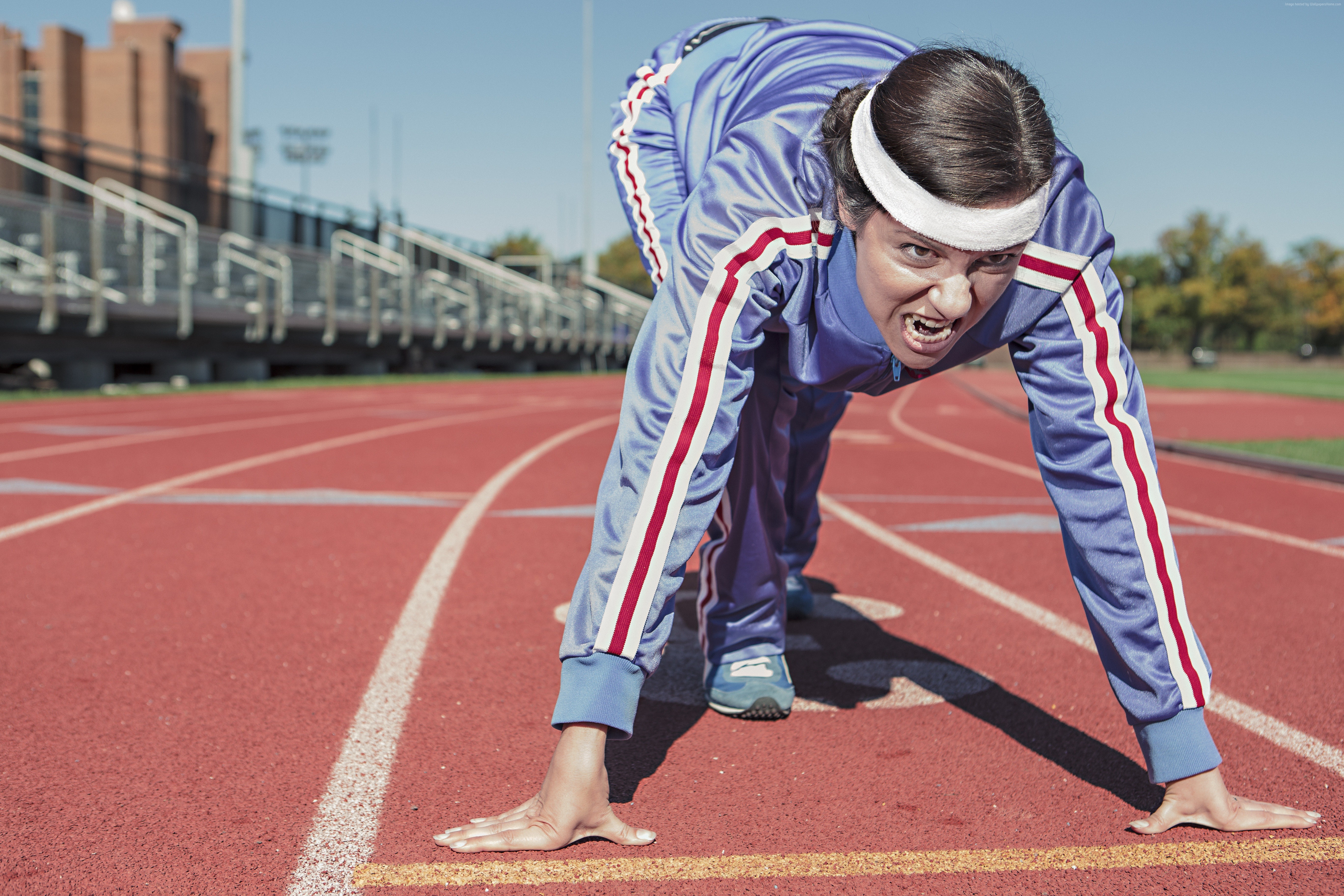 Woman in tracksuit at starting line of a race HD Wallpaper