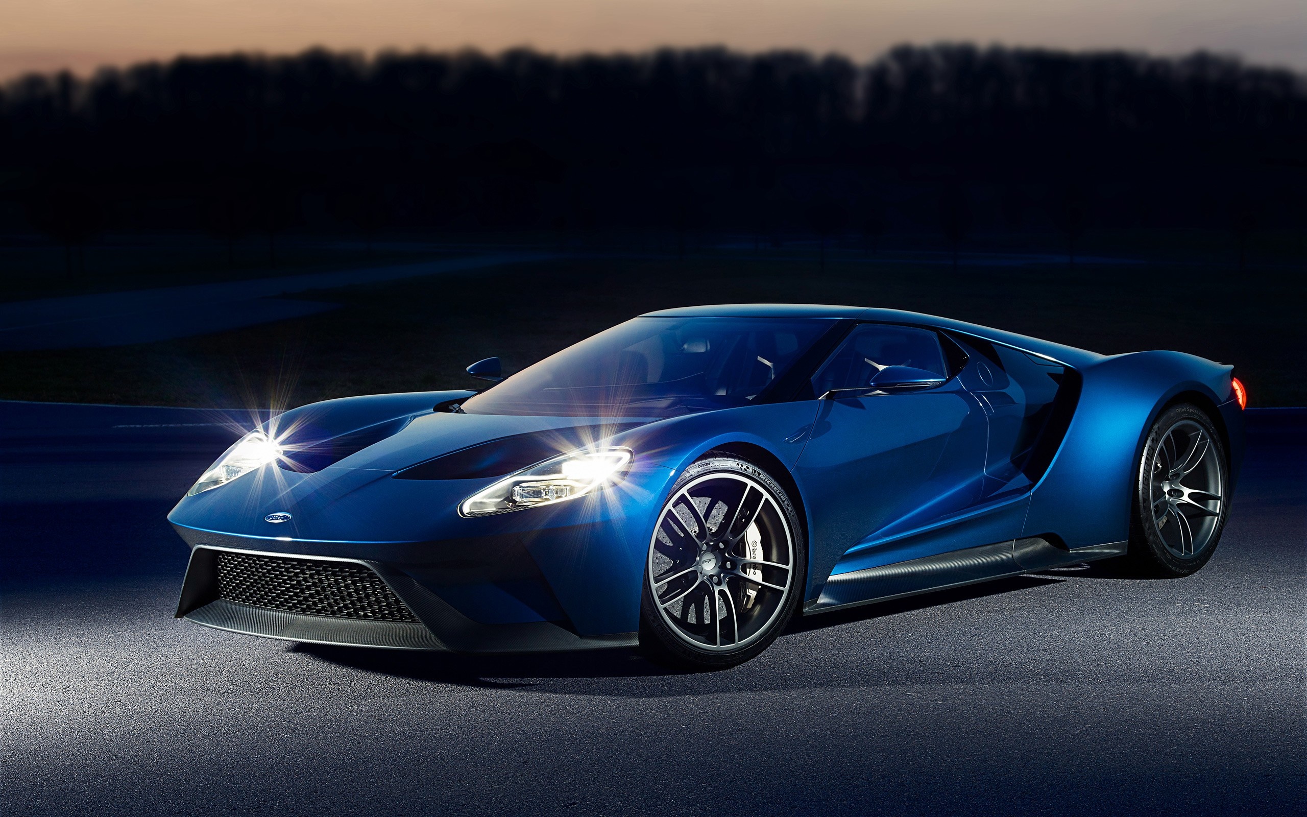 Blue Ford GT sports car on a dark road HD Wallpaper