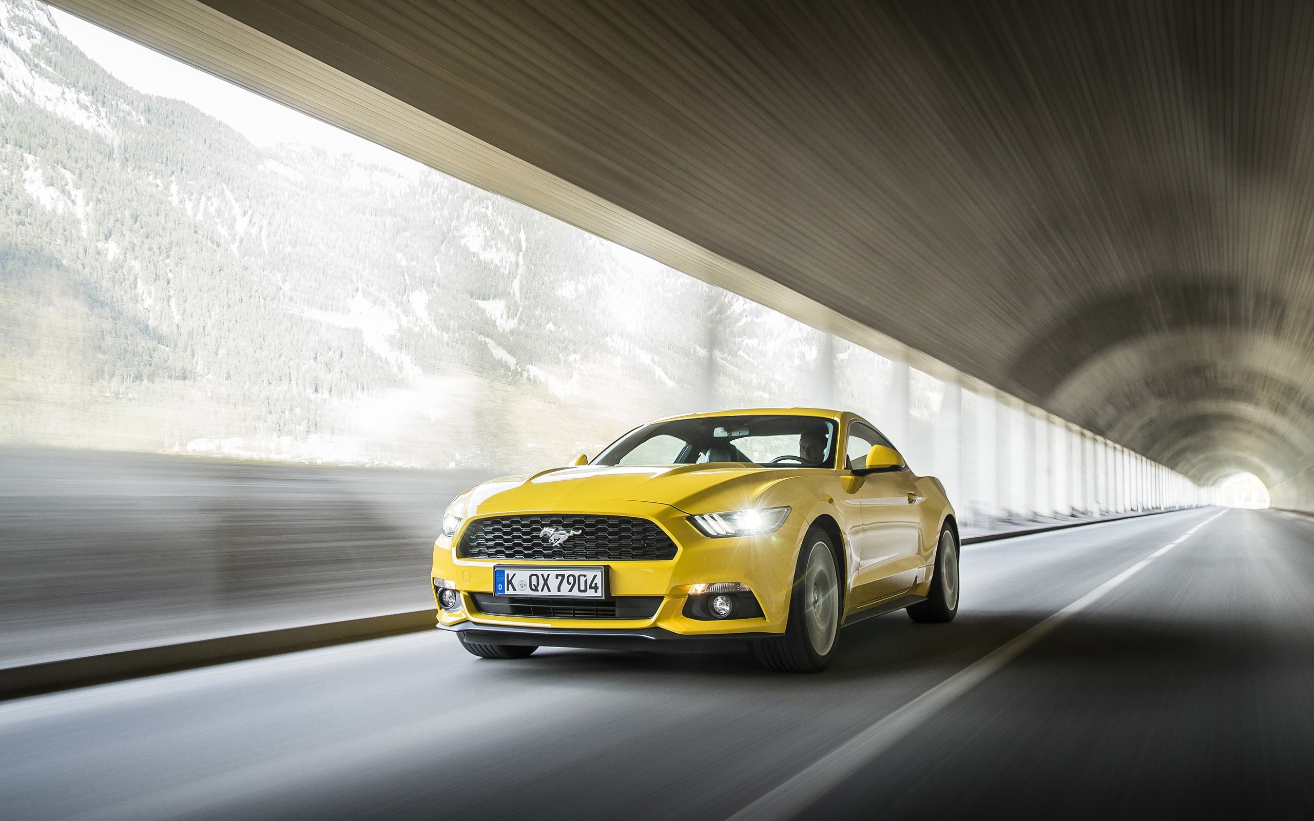 Yellow Ford Mustang GT driving out of a tunnel HD Wallpaper
