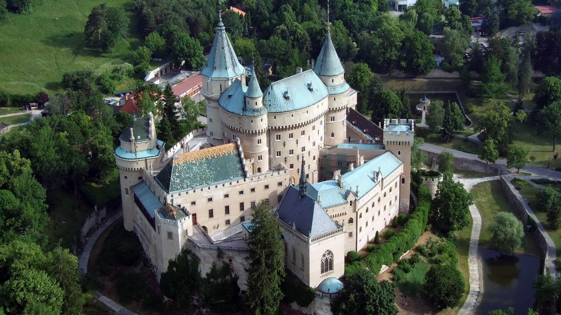 Bojnice Castle Surrounded by Lush Greenery and Trees HD Wallpaper