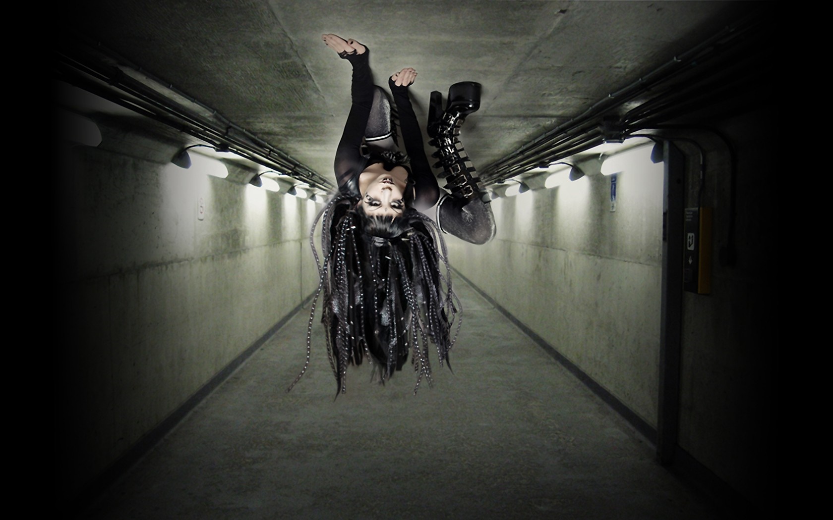 Woman with dreadlocks upside down in a tunnel HD Wallpaper