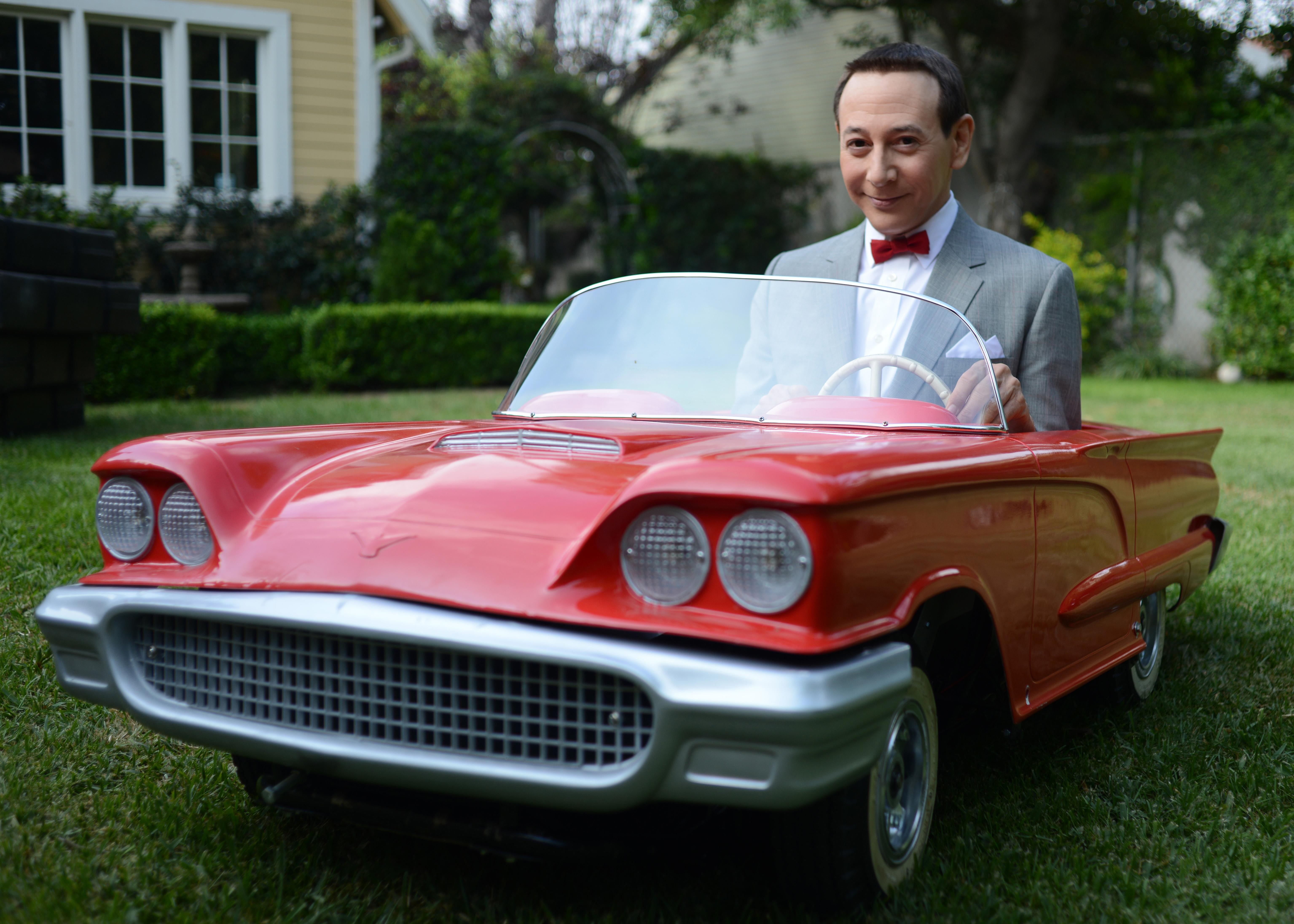 Pee-wee Herman in a red toy car HD Wallpaper