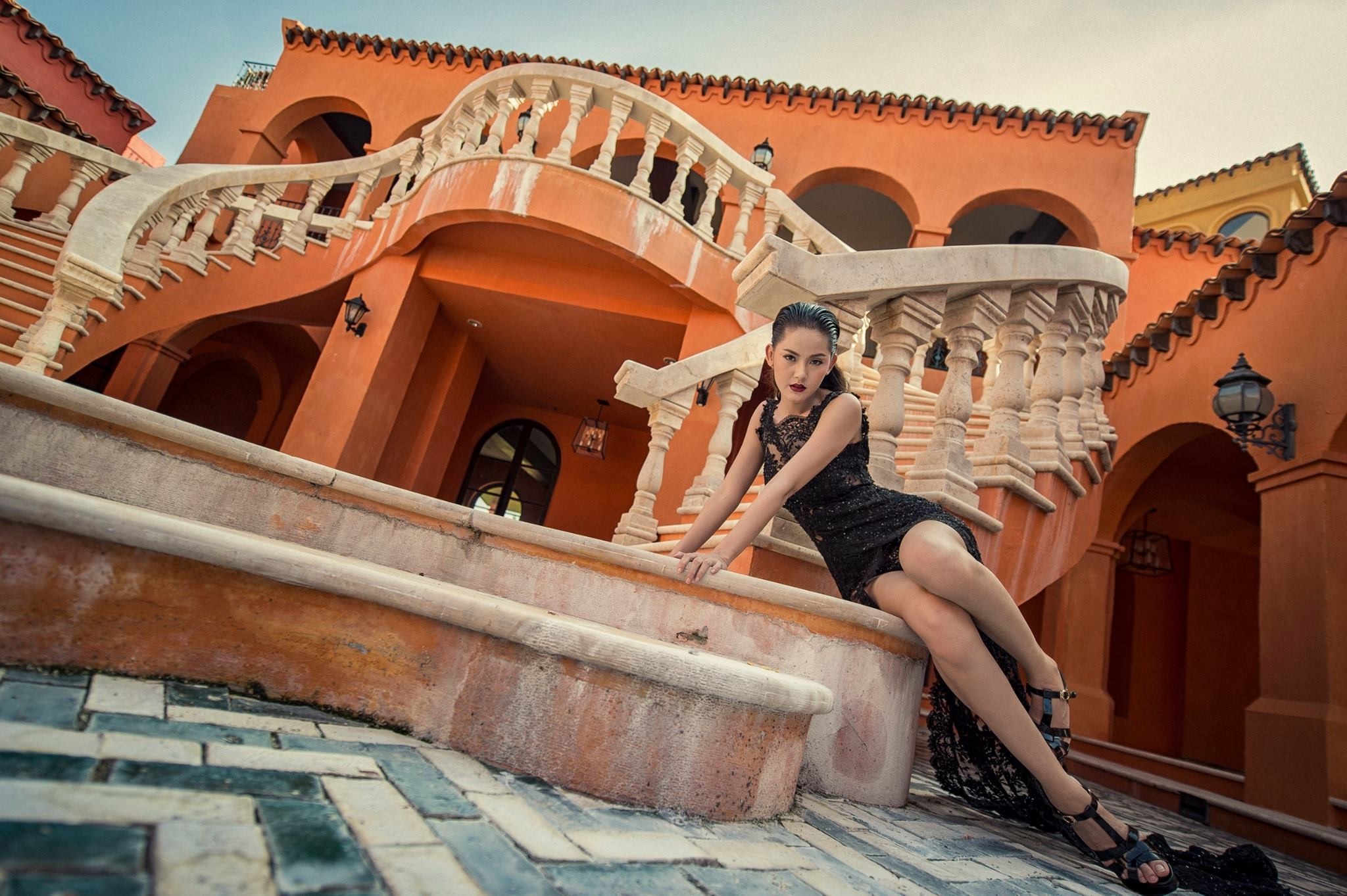 Woman in black dress posing on stairs HD Wallpaper