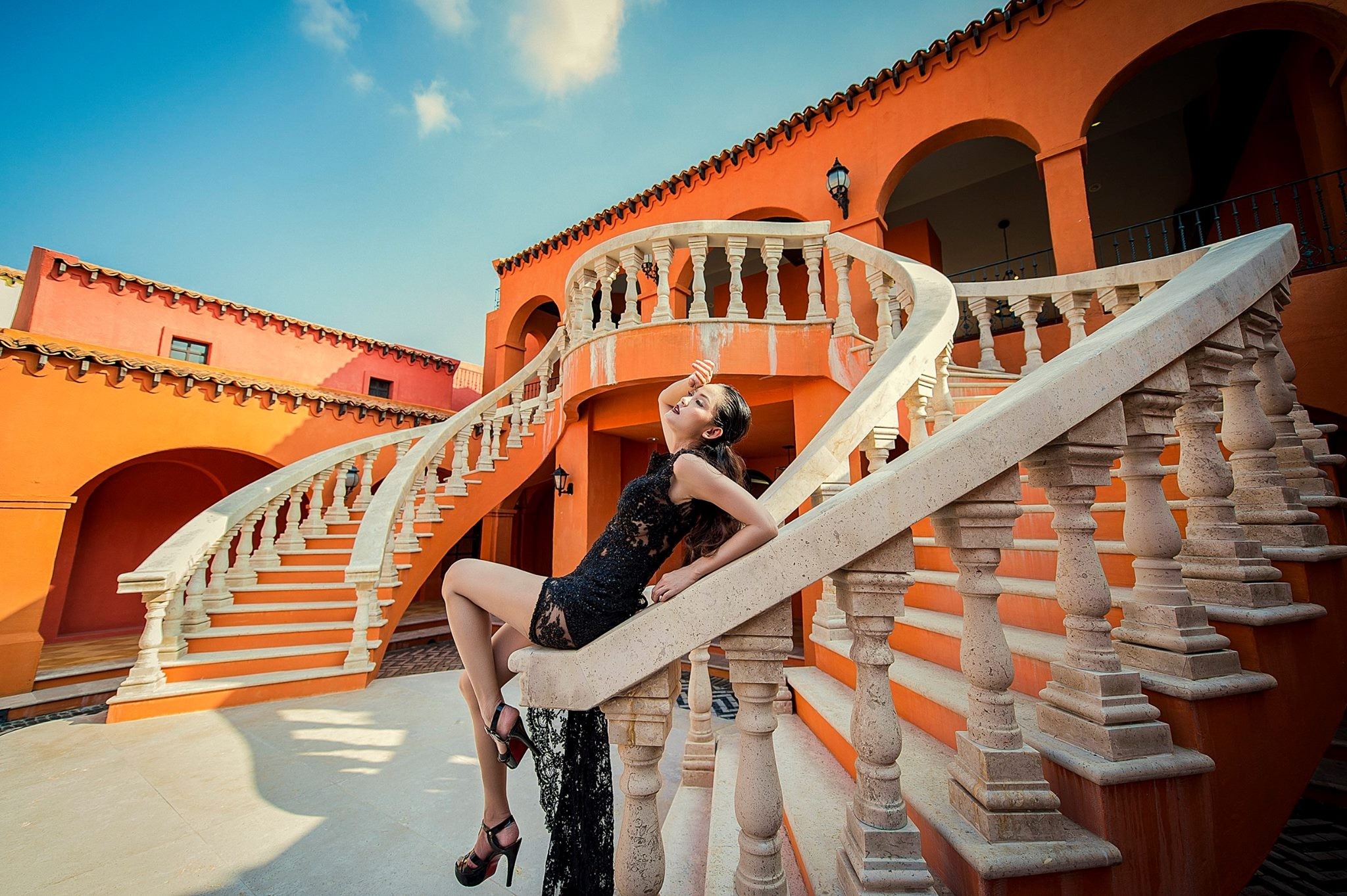 Woman in black dress on ornate stairs HD Wallpaper