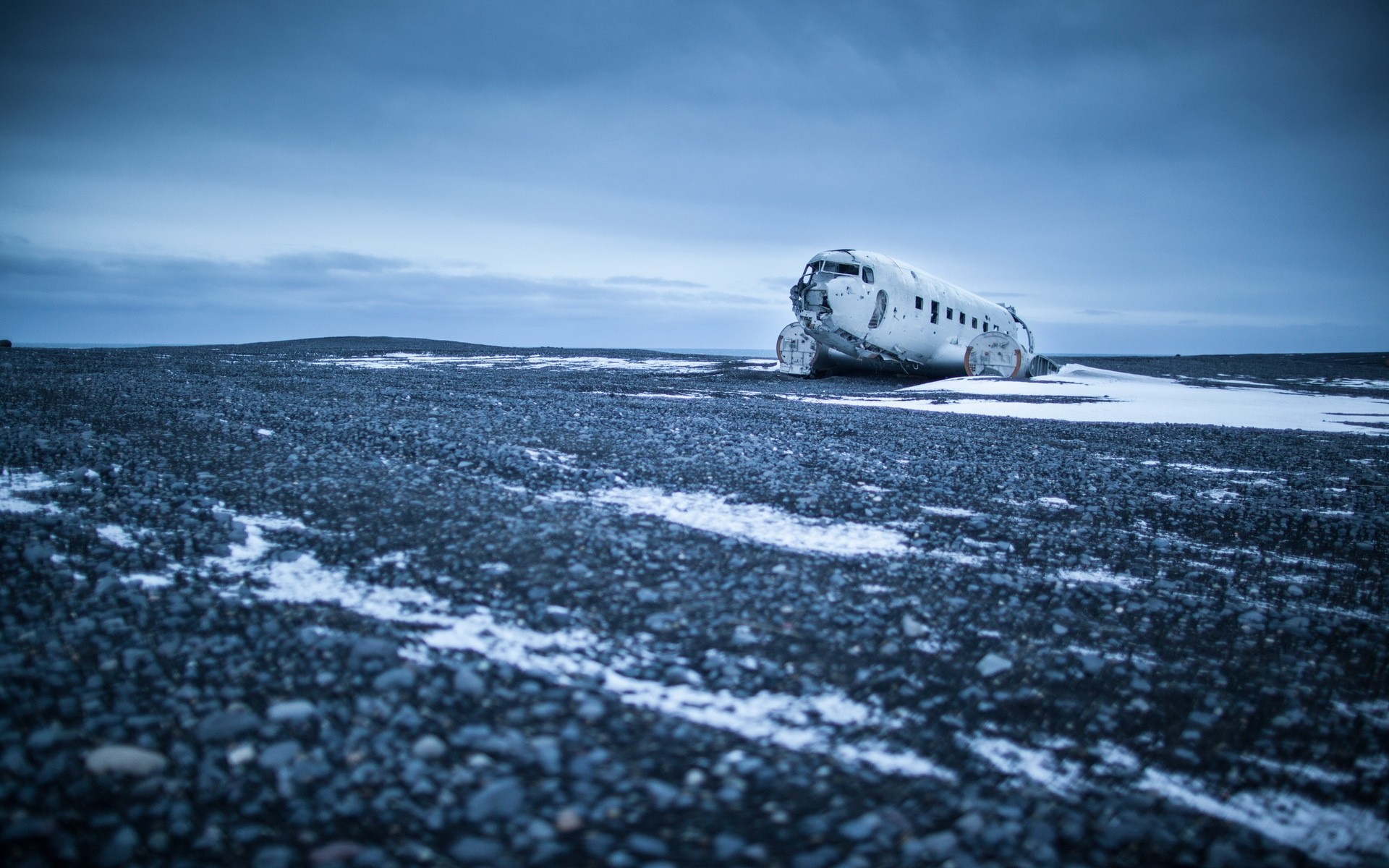 Abandoned airplane wreck on a desolate, snowy landscape HD Wallpaper