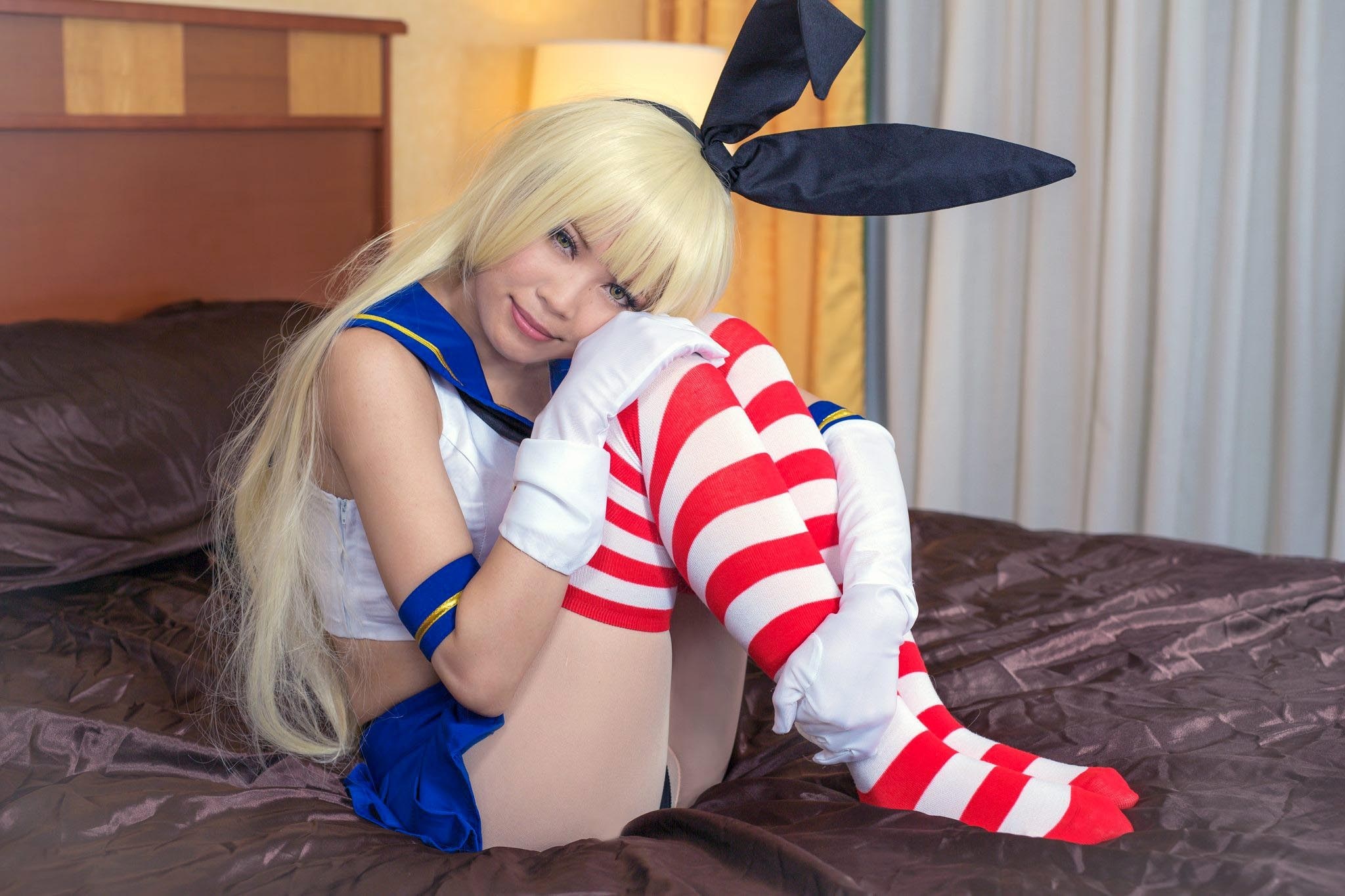 Cosplayer in sailor-style outfit with bunny ears and striped socks HD Wallpaper