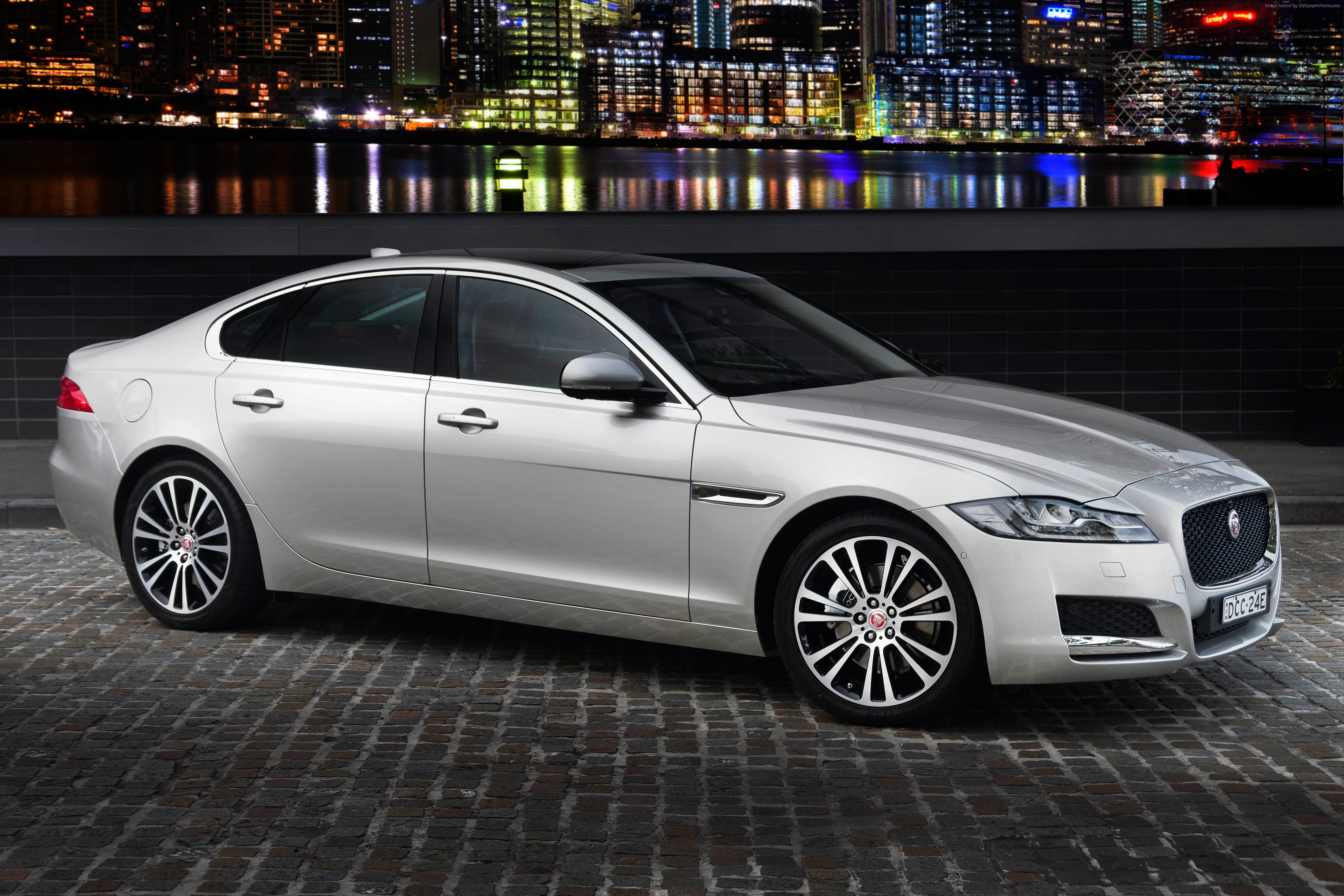 Silver Jaguar XF Portfolio sedan parked on cobblestone street HD Wallpaper