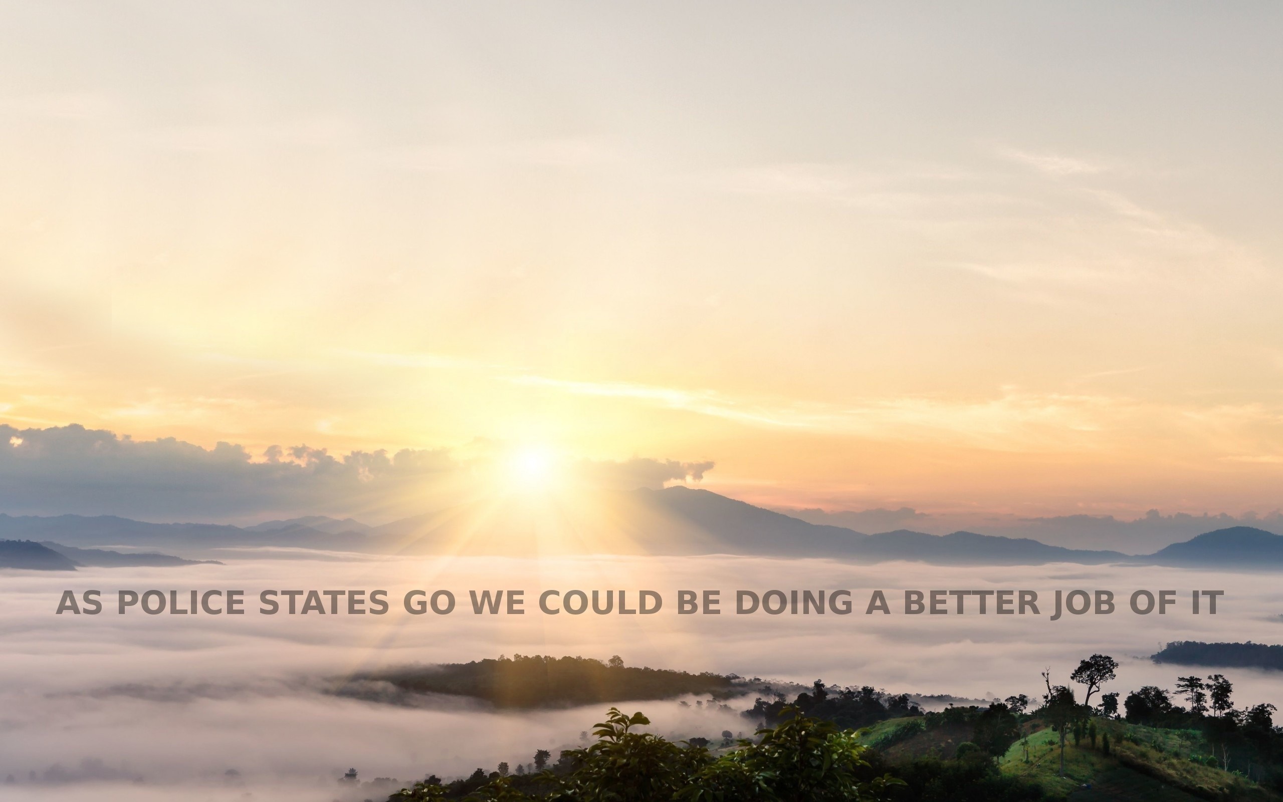 Sunrise over misty mountains with text overlay HD Wallpaper