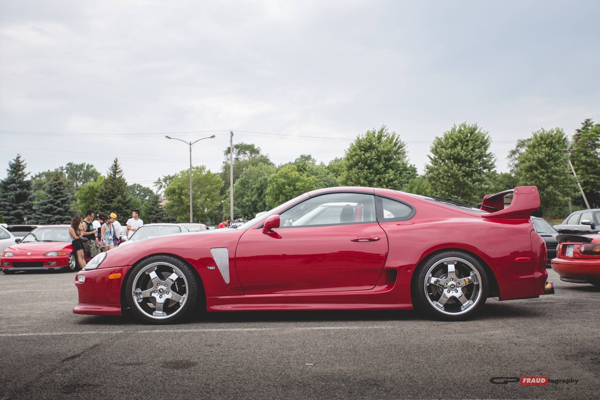 Red Toyota Supra parked at car show HD Wallpaper