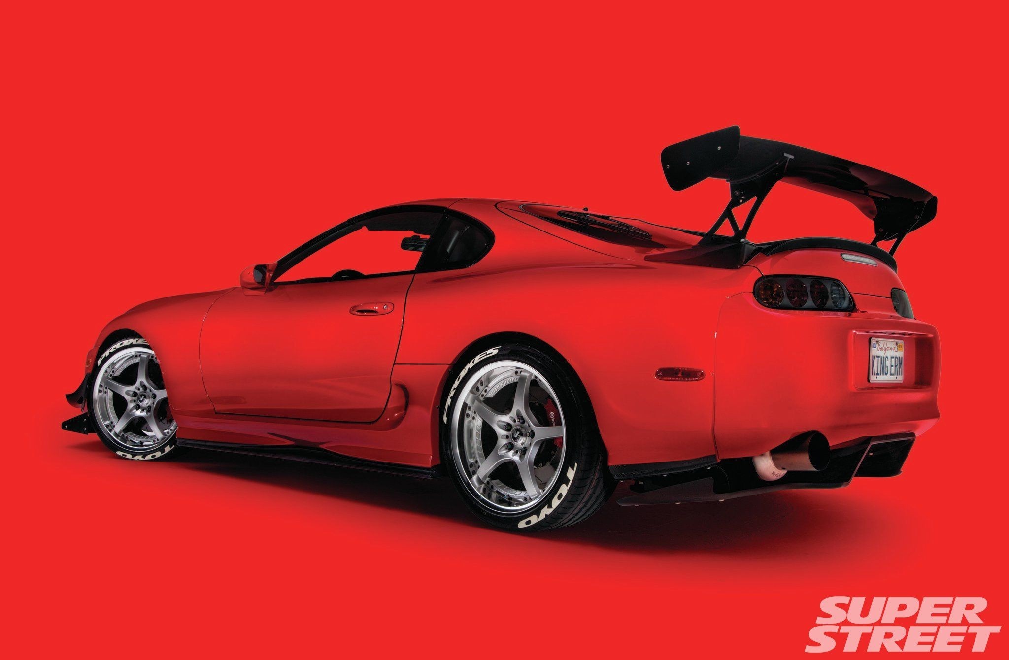 Red Toyota Supra with large rear spoiler HD Wallpaper