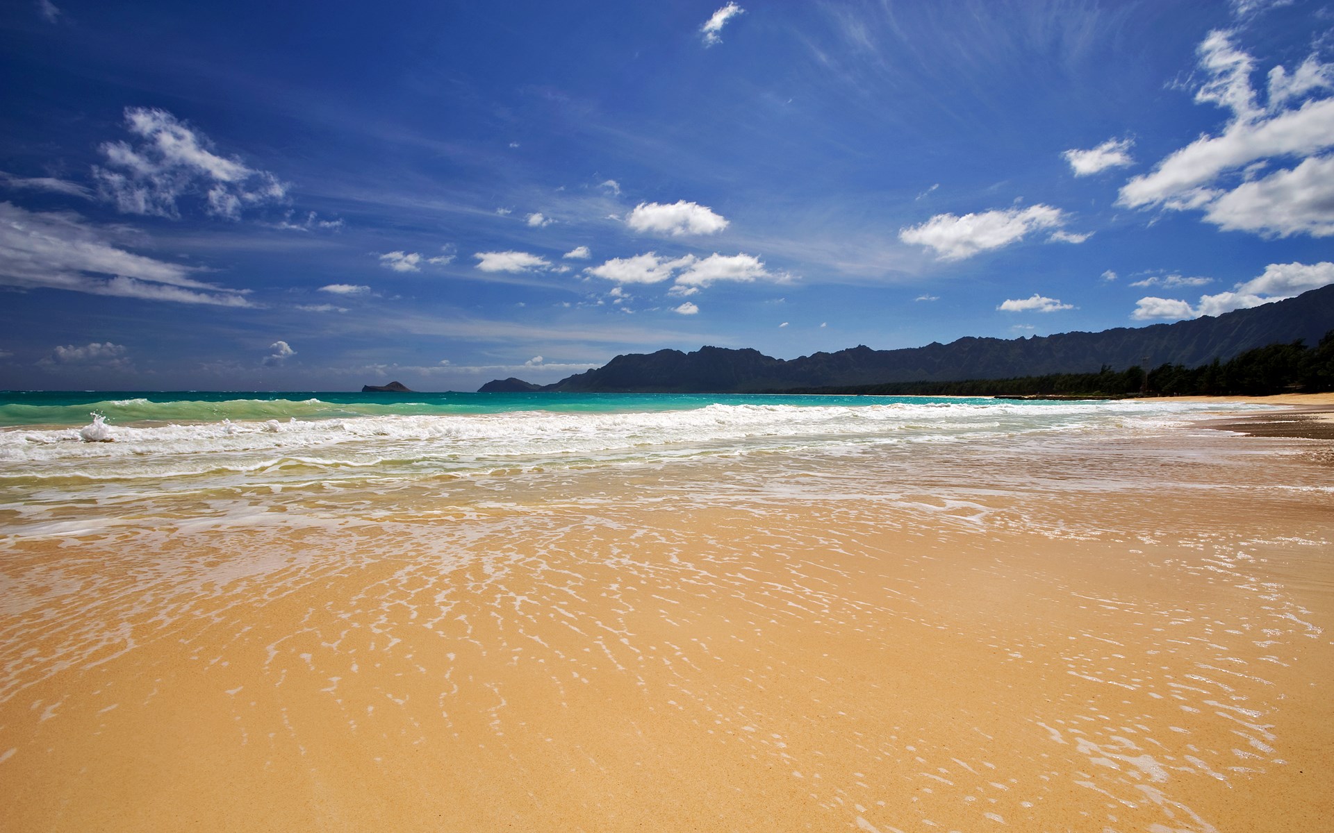 Sandy beach with waves and mountains HD Wallpaper