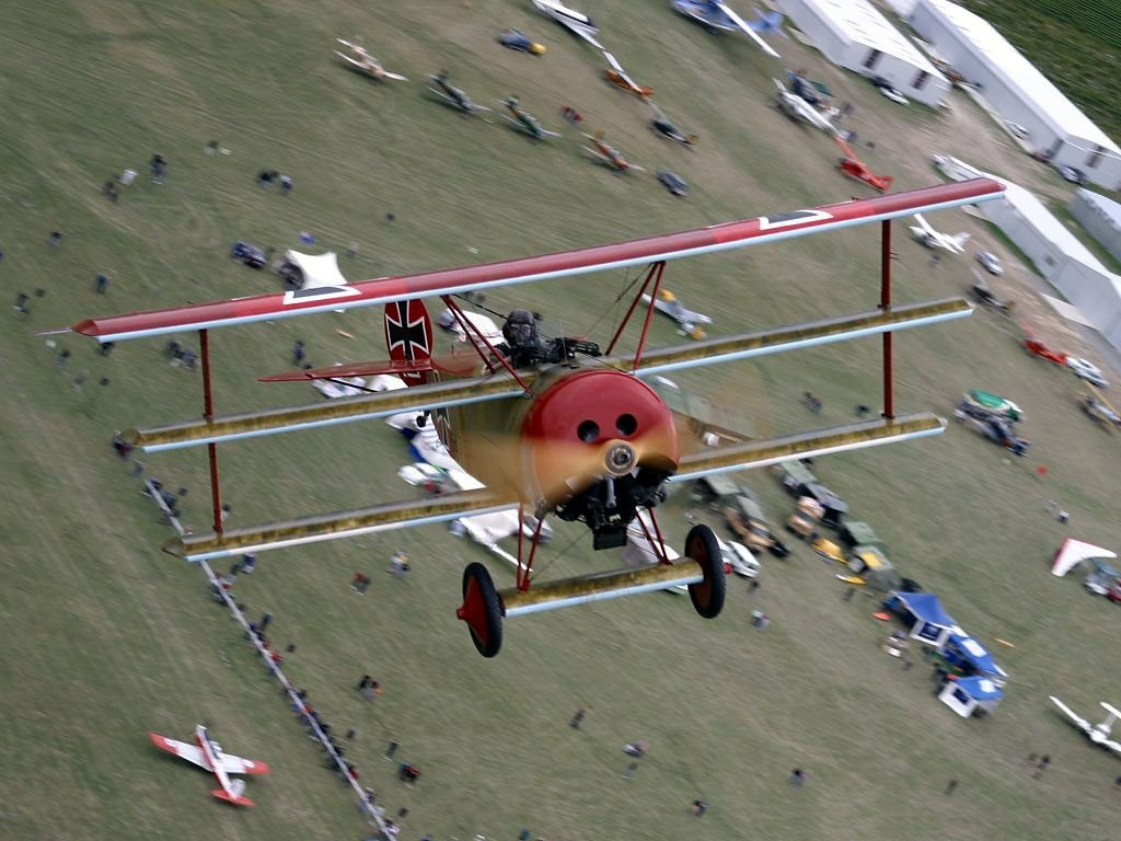 Fokker Dr.1 Triplane in flight over an airshow HD Wallpaper