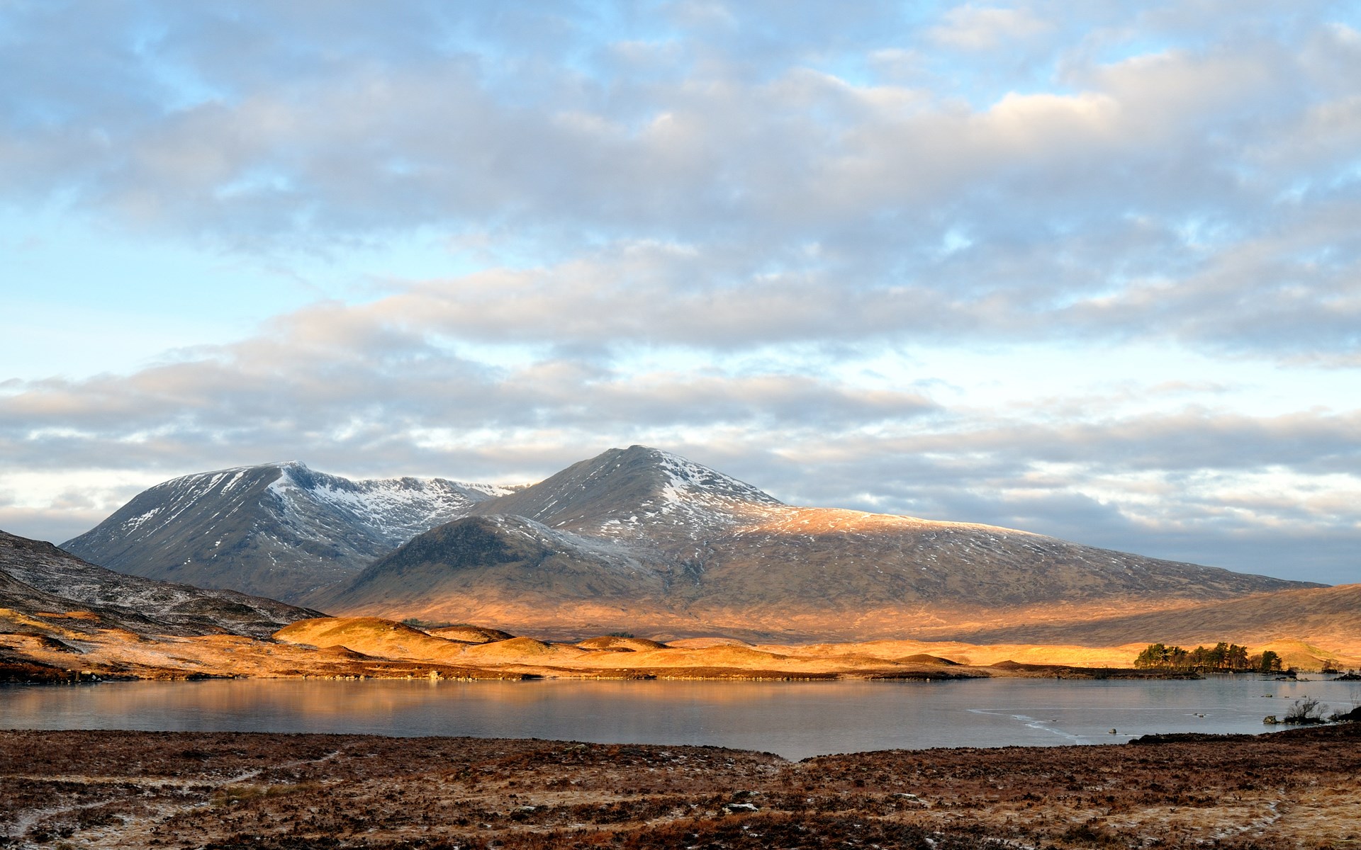 Snow-capped mountains reflected in a lake at sunset HD Wallpaper