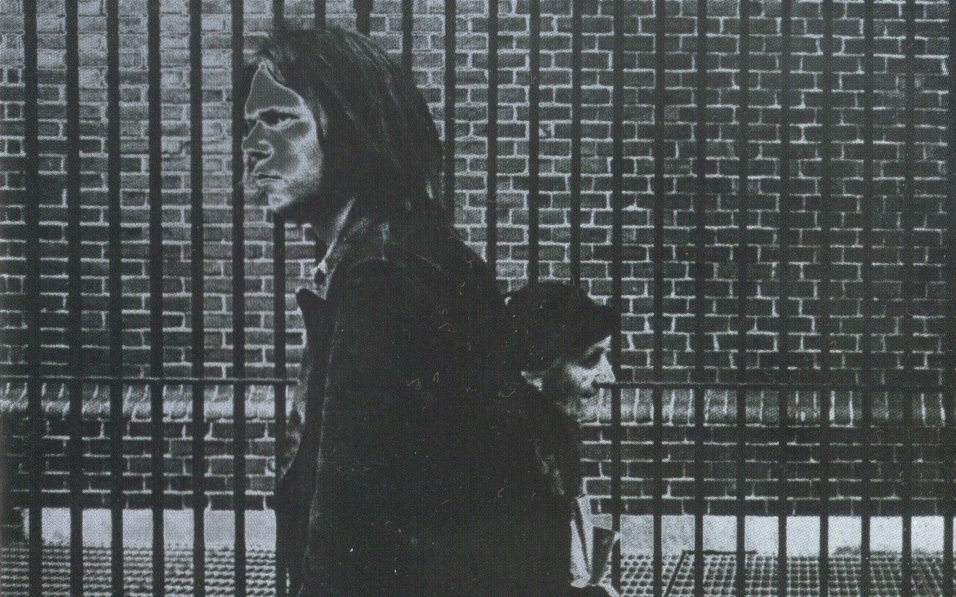 Neil Young and another person in front of a brick wall HD Wallpaper