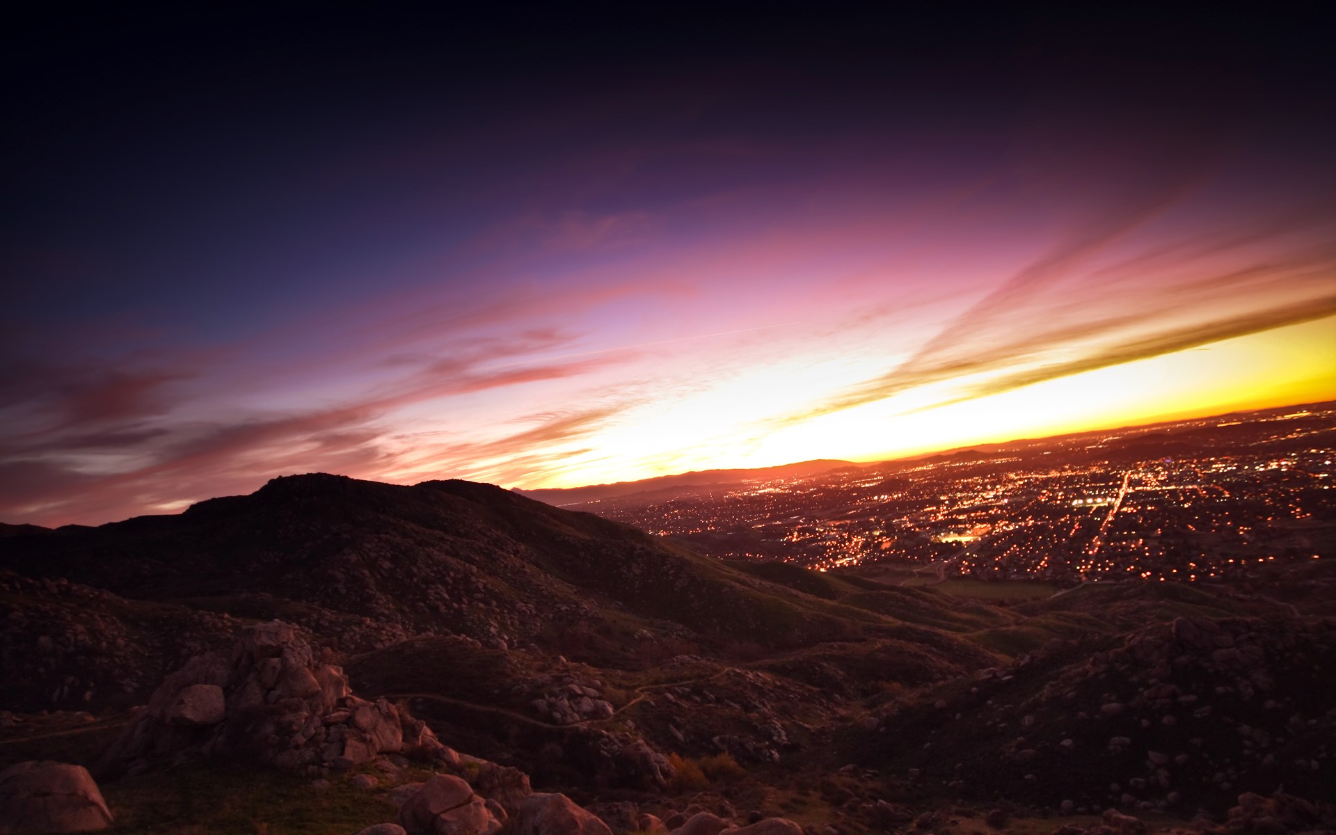 City lights at sunset over mountains HD Wallpaper