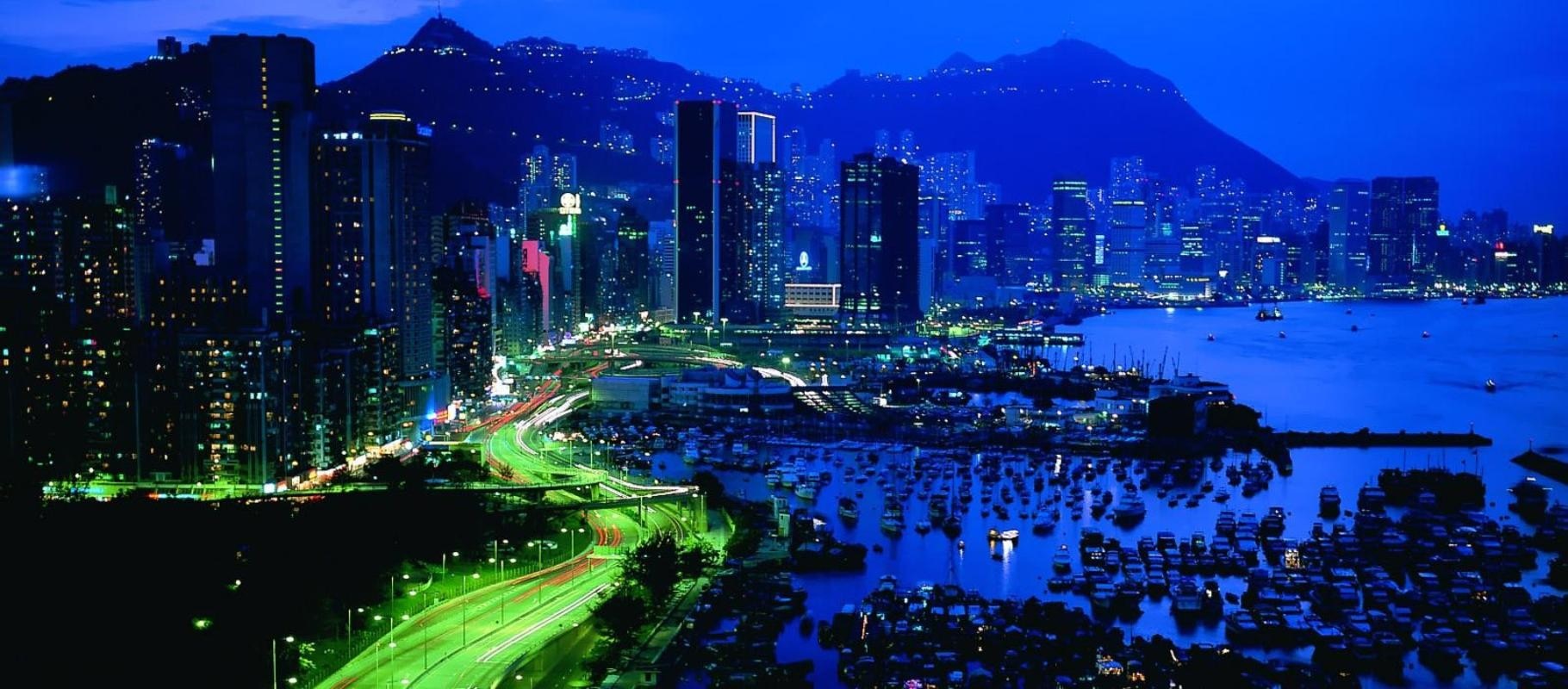 Hong Kong cityscape at night with harbor and mountains HD Wallpaper