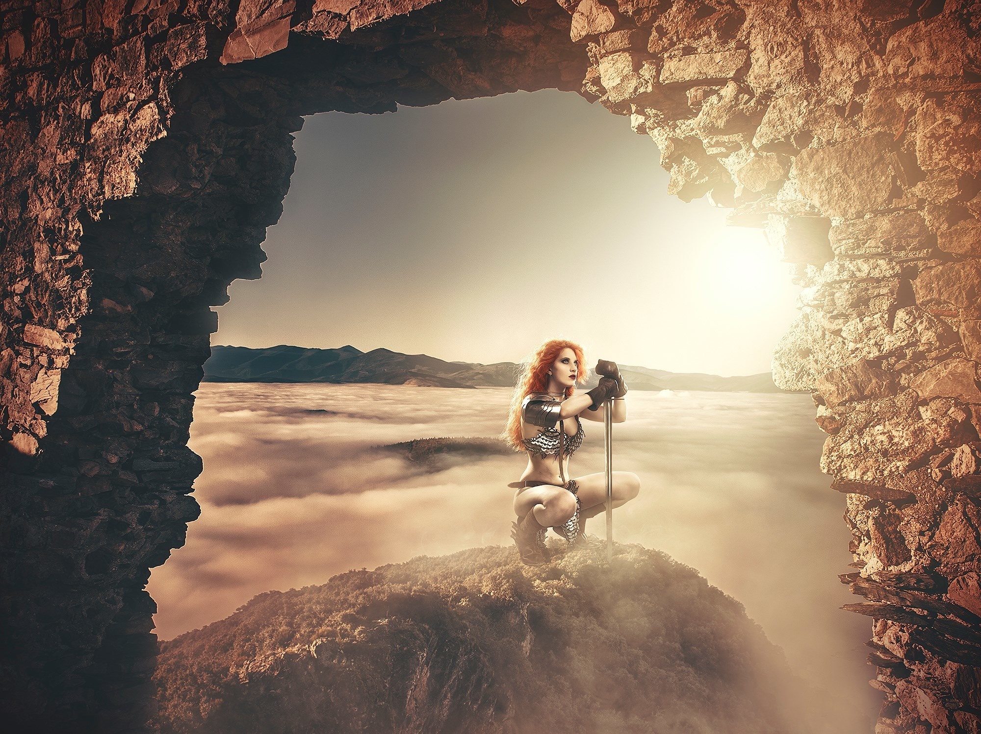 Fantasy warrior woman with sword in rocky archway over clouds HD Wallpaper