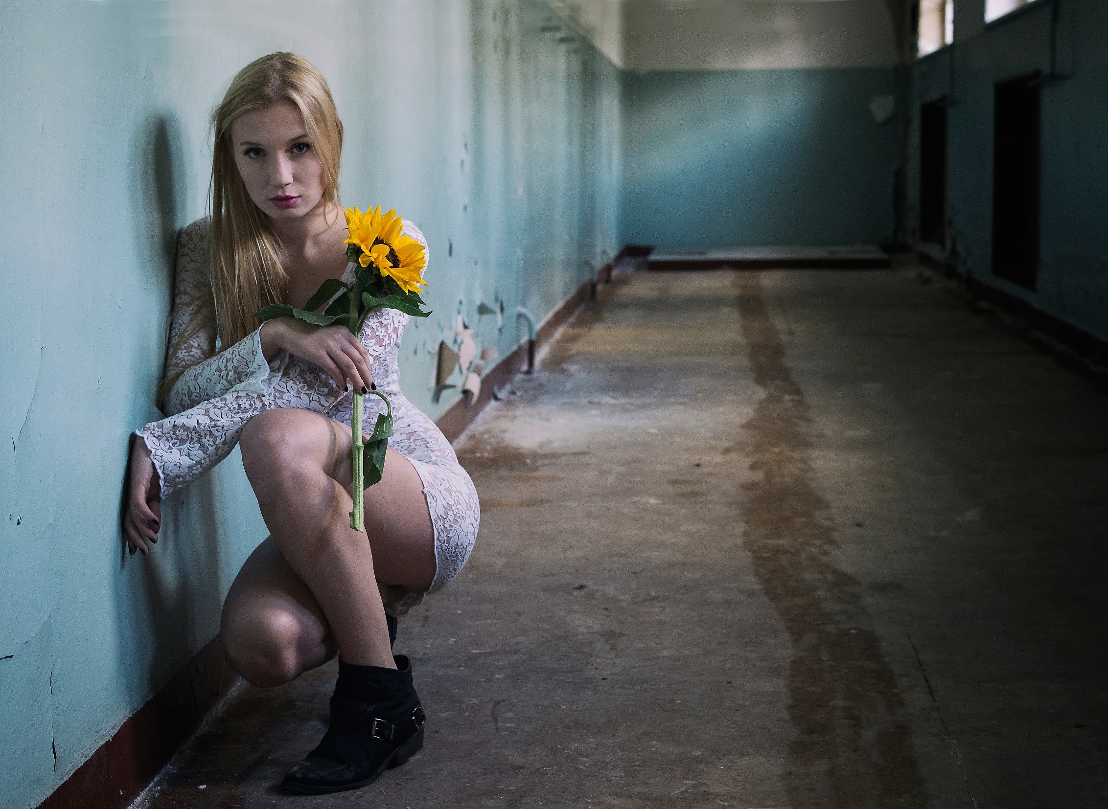 Woman with sunflower in abandoned hallway HD Wallpaper