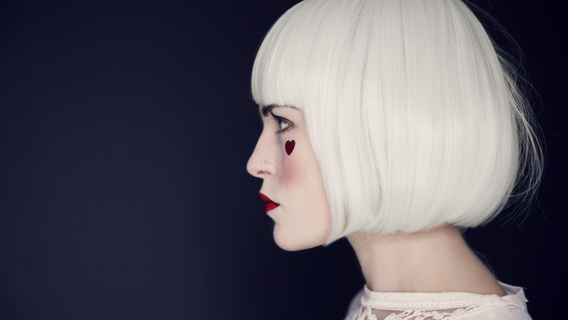 Woman with white wig and heart makeup in profile HD Wallpaper