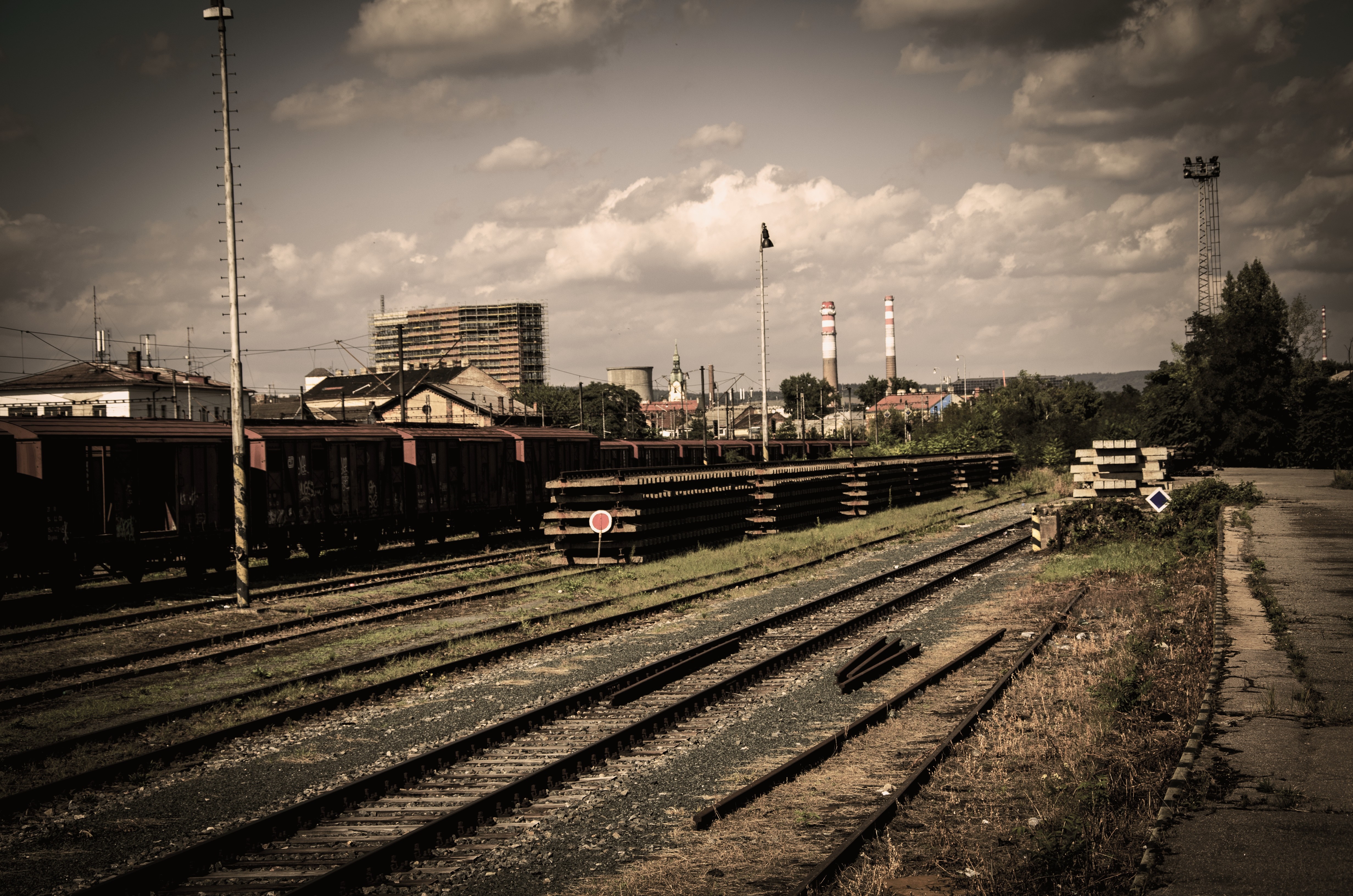 Abandoned train yard with industrial buildings HD Wallpaper