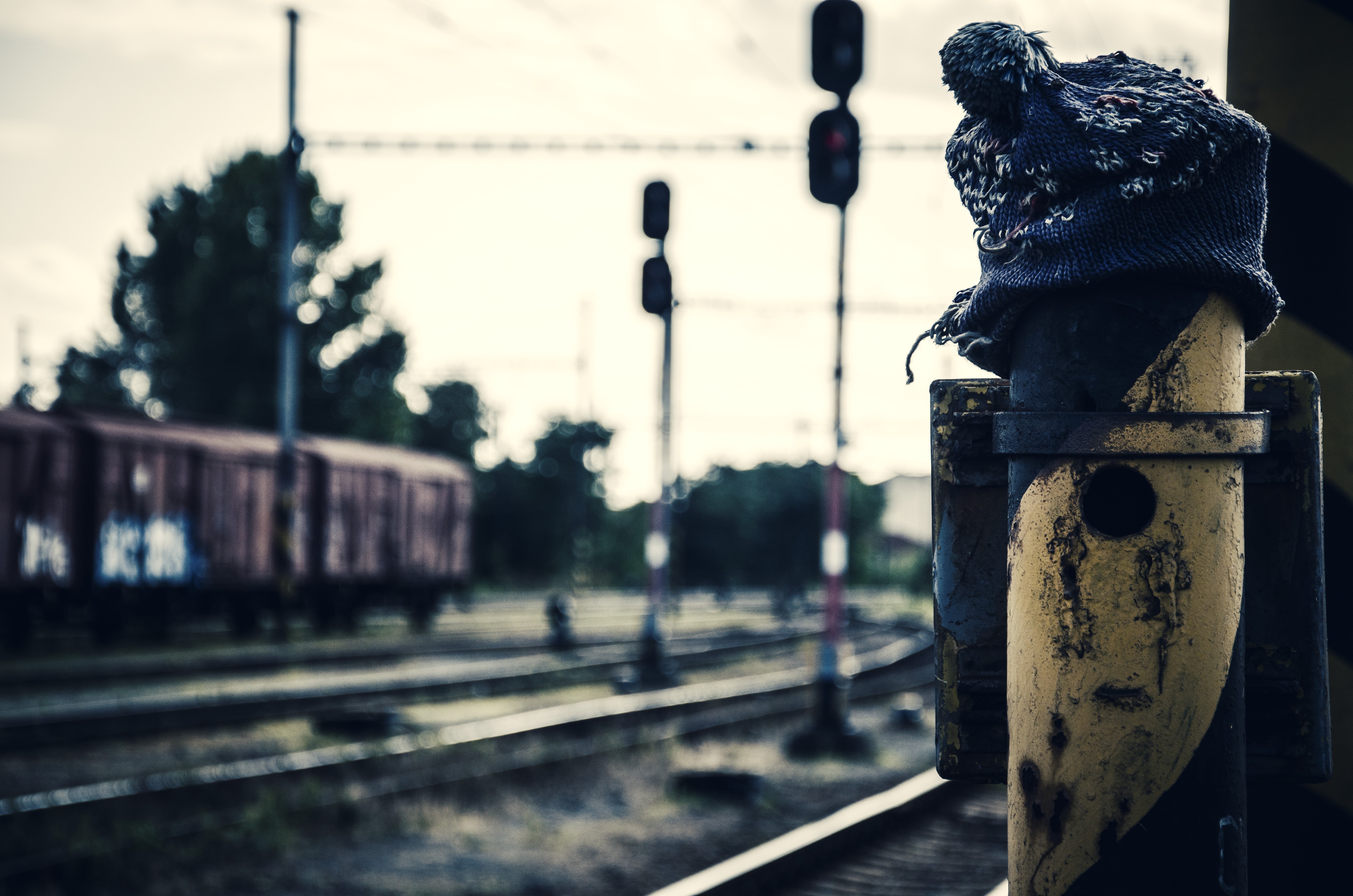 Train station with a woolly hat on a post HD Wallpaper