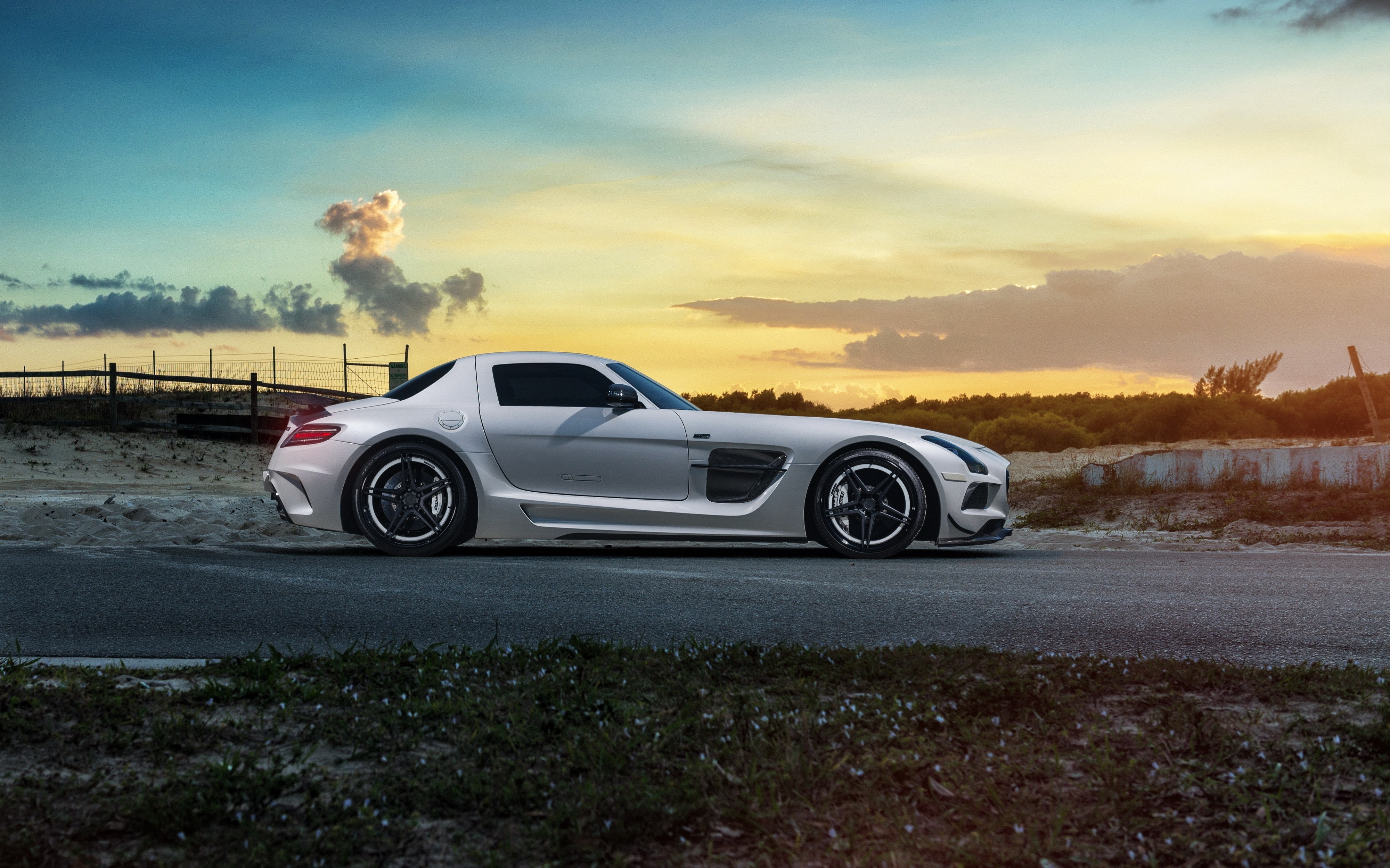 Silver Mercedes Benz SLS AMG parked on a road HD Wallpaper
