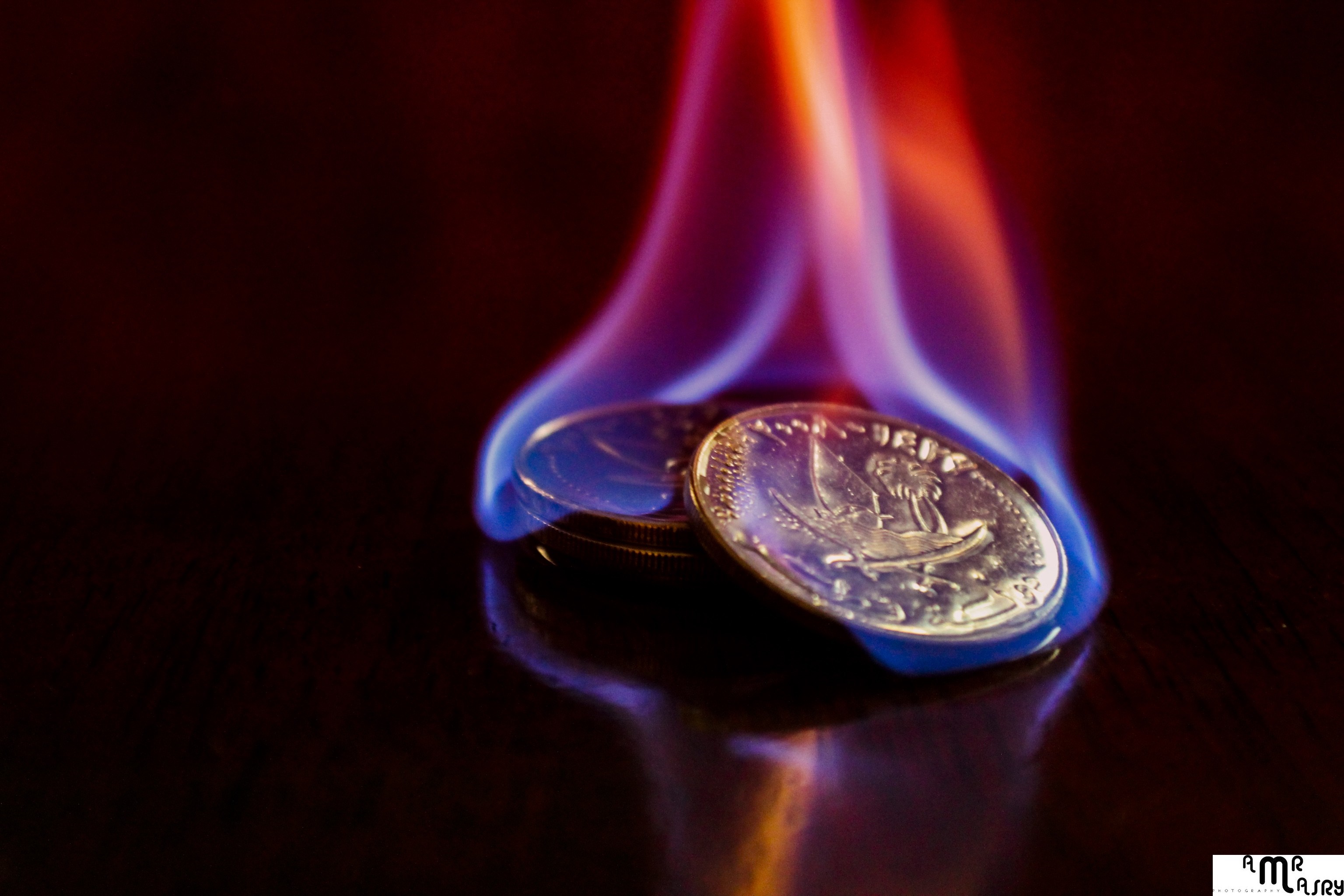 Coins on fire with blue and orange flames HD Wallpaper