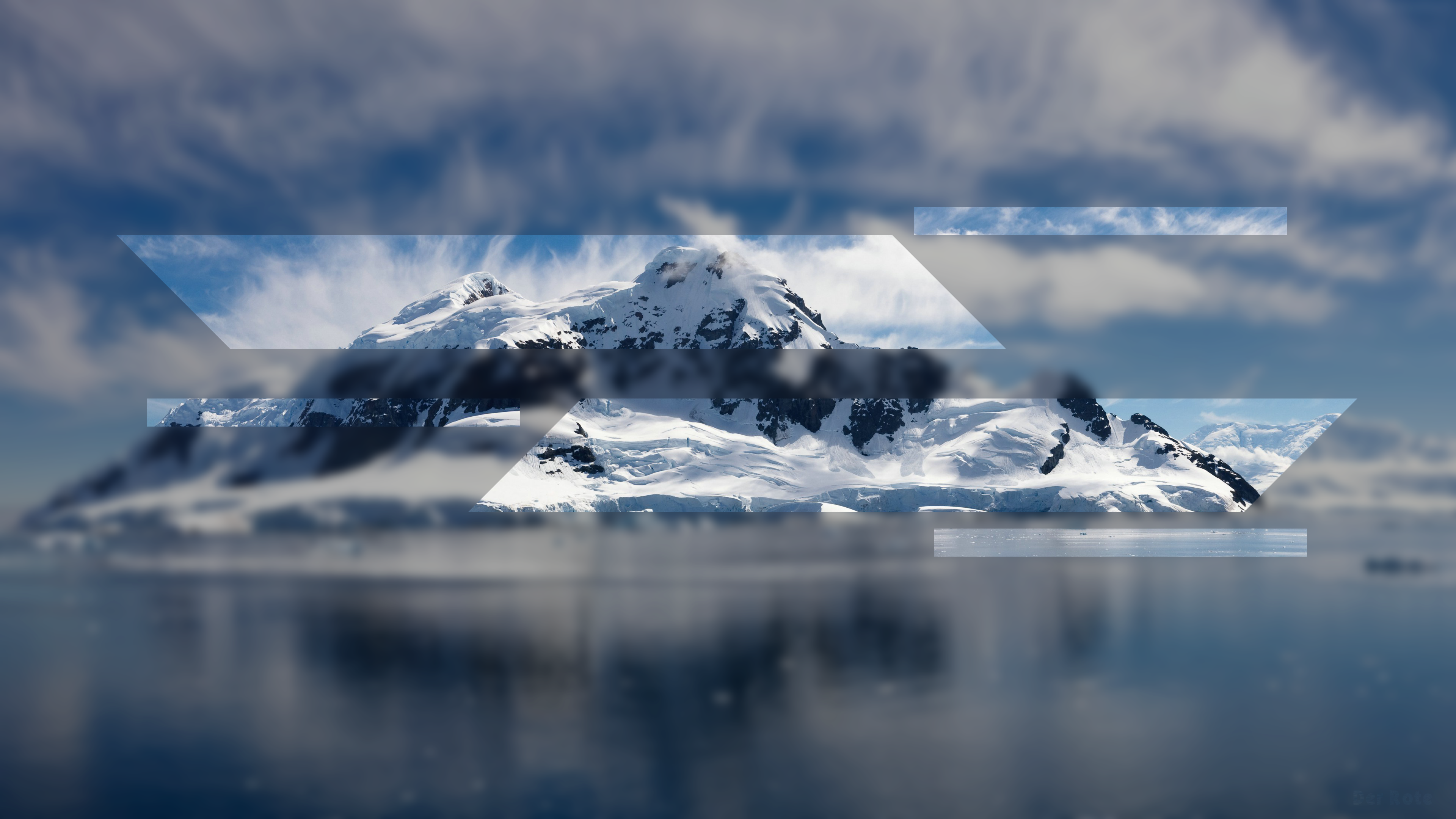 Snowy mountains reflected in the ocean under a cloudy sky HD Wallpaper