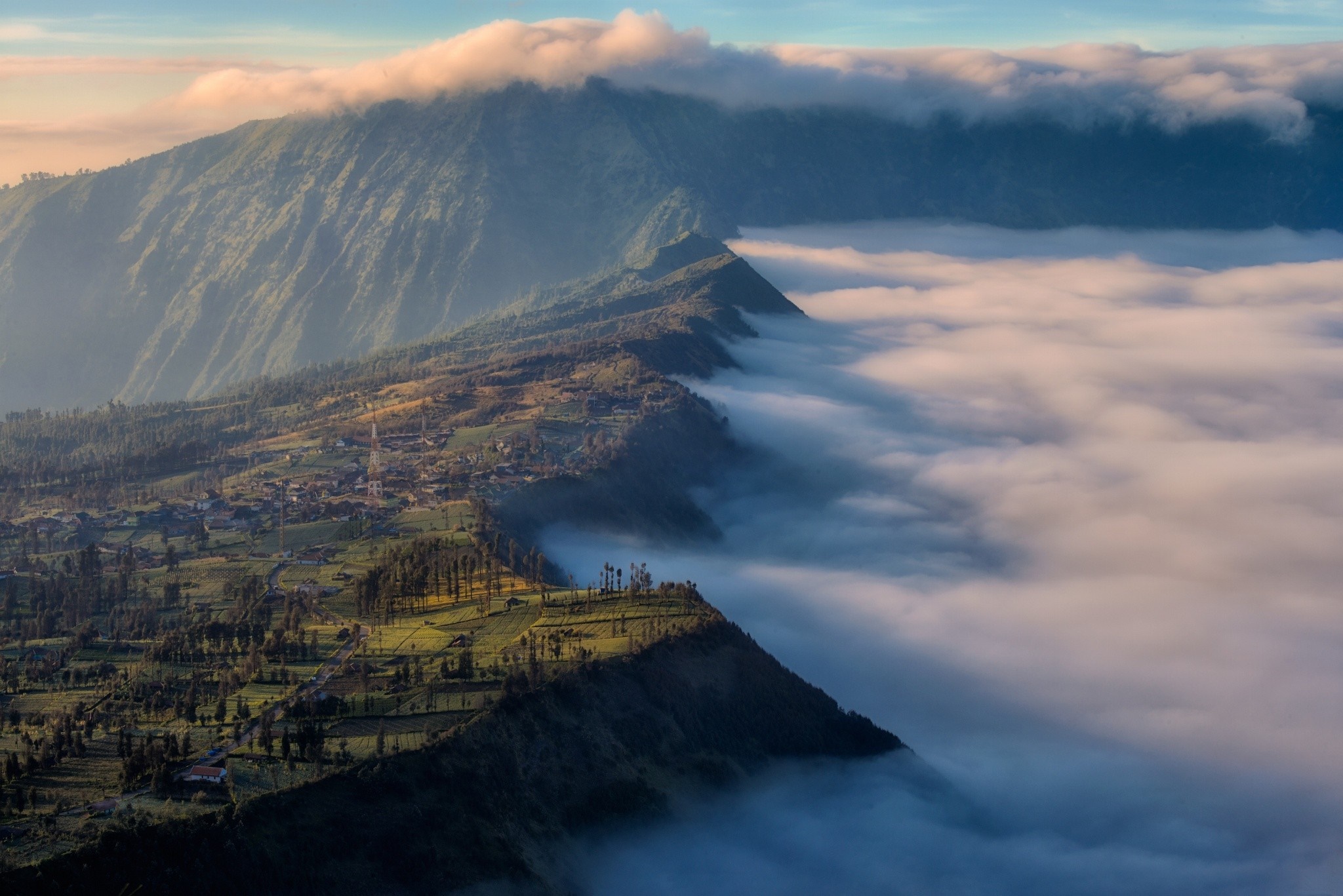 Mountain range covered in clouds at sunrise HD Wallpaper