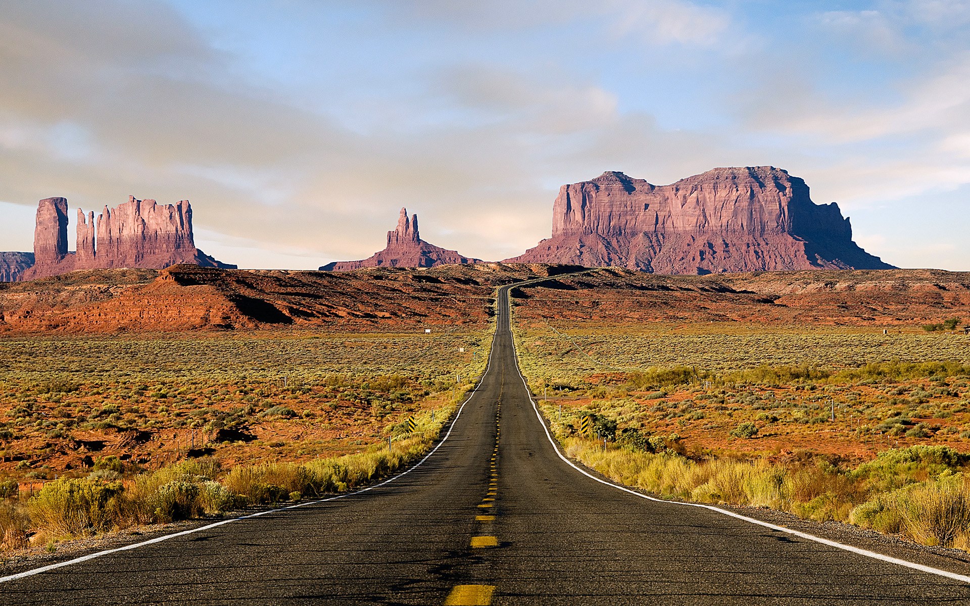 Monument Valley Road with Red Rock Formations HD Wallpaper