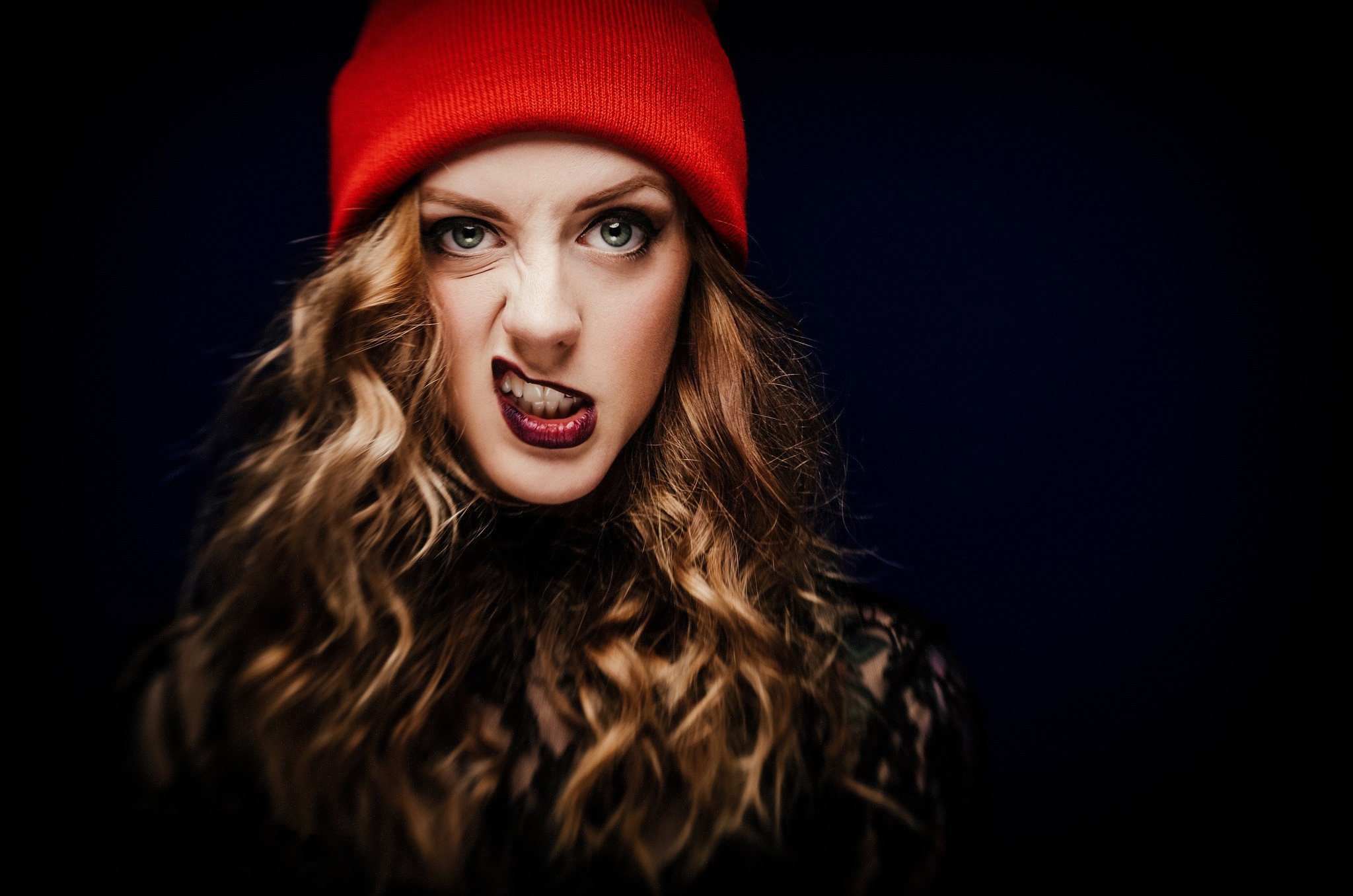 Woman wearing a red beanie and dark clothing HD Wallpaper