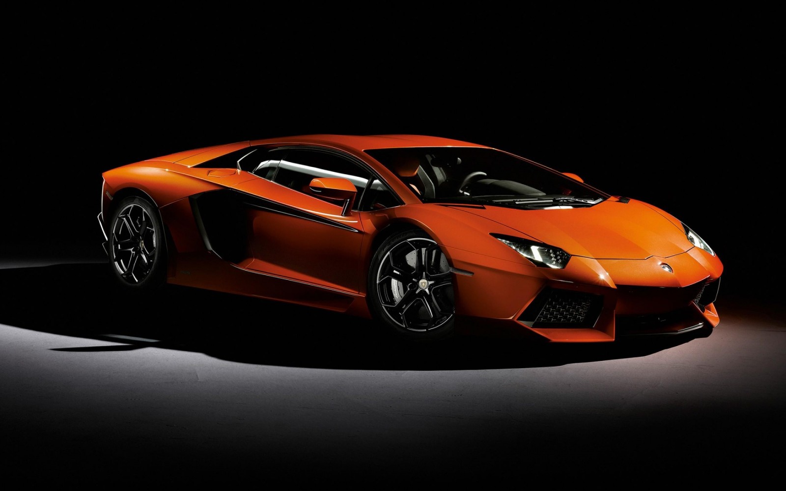 Orange Lamborghini Aventador parked on a dark surface HD Wallpaper