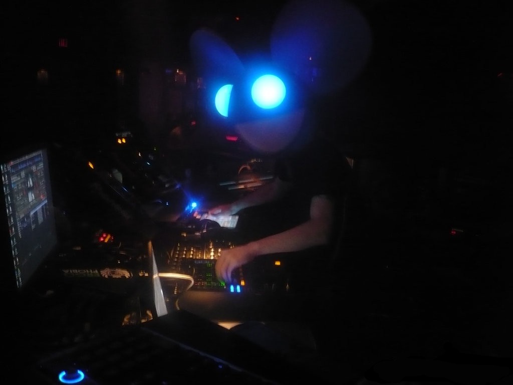 Deadmau5 performing in a nightclub with DJ equipment HD Wallpaper